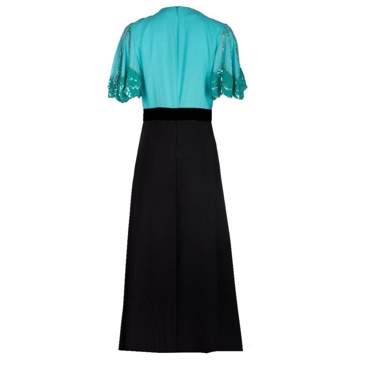 A gown with a deep V neckline with crystals, sequins details at top, and belt brooch at waist. 
Black and green silk.
Deep V-neck.
Back zip closure.
95% Silk, 5% polyester.
Trimming: 50% polyester, 20% silk, 20%wool, 10% cotton
Made in Italy.
Master