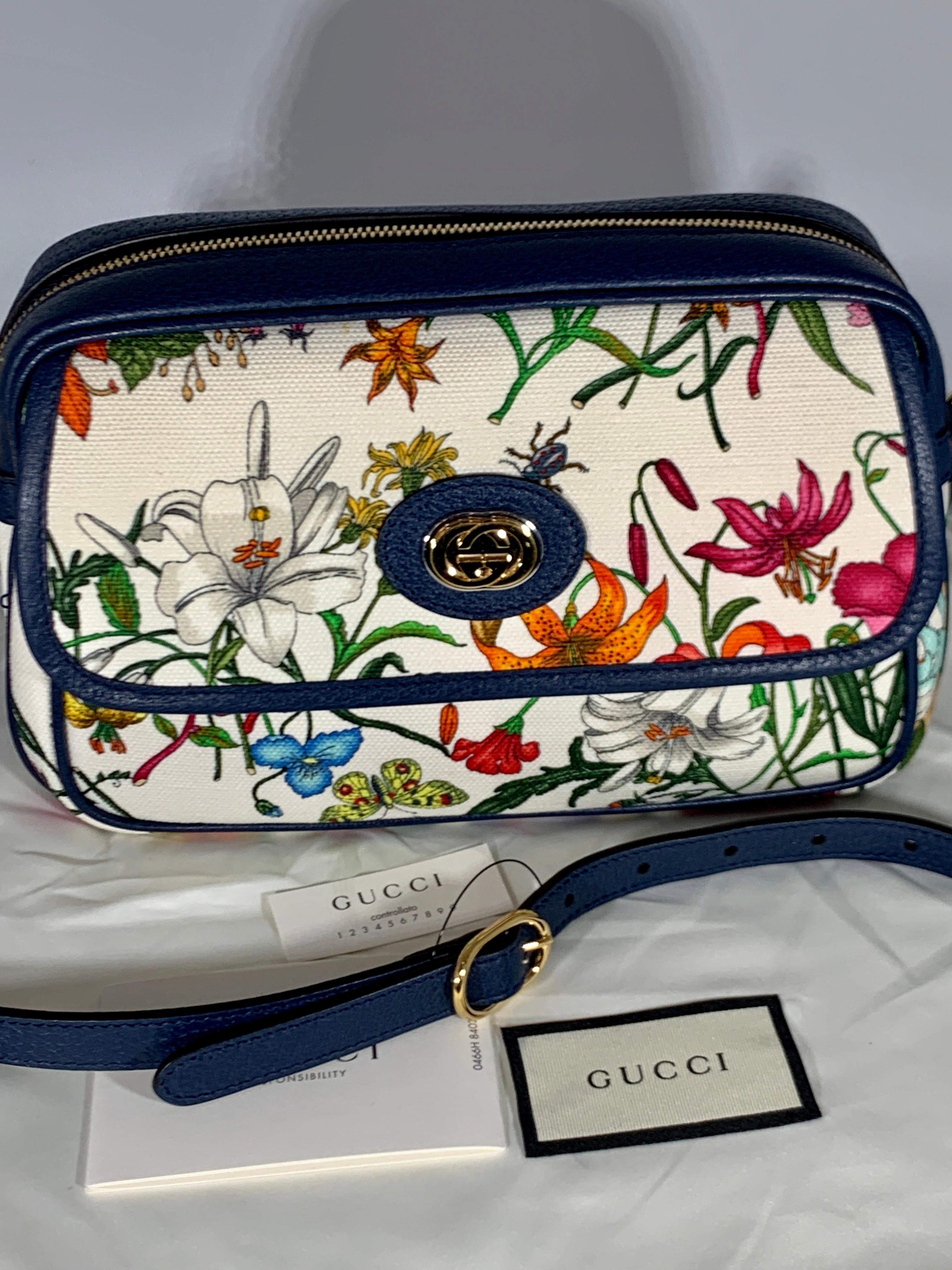 Flora Small  leather-trimmed printed canvas tote
Latest and Hot 
Brand new Gucci Flora small sized handbag. With an off white canvas with a bright colorful floral pattern. The tote features Blue  leather at the base, trim, and Have  leather shoulder