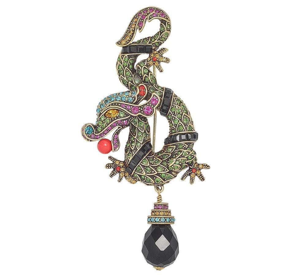 Let your style take flight in this exquisite crystal and bead intensive design by Heidi Daus.

Its exotic presence is bound to capture everyone's interest including yours. Whether it's worn as a pin or on necklace cord it is destined to stir up