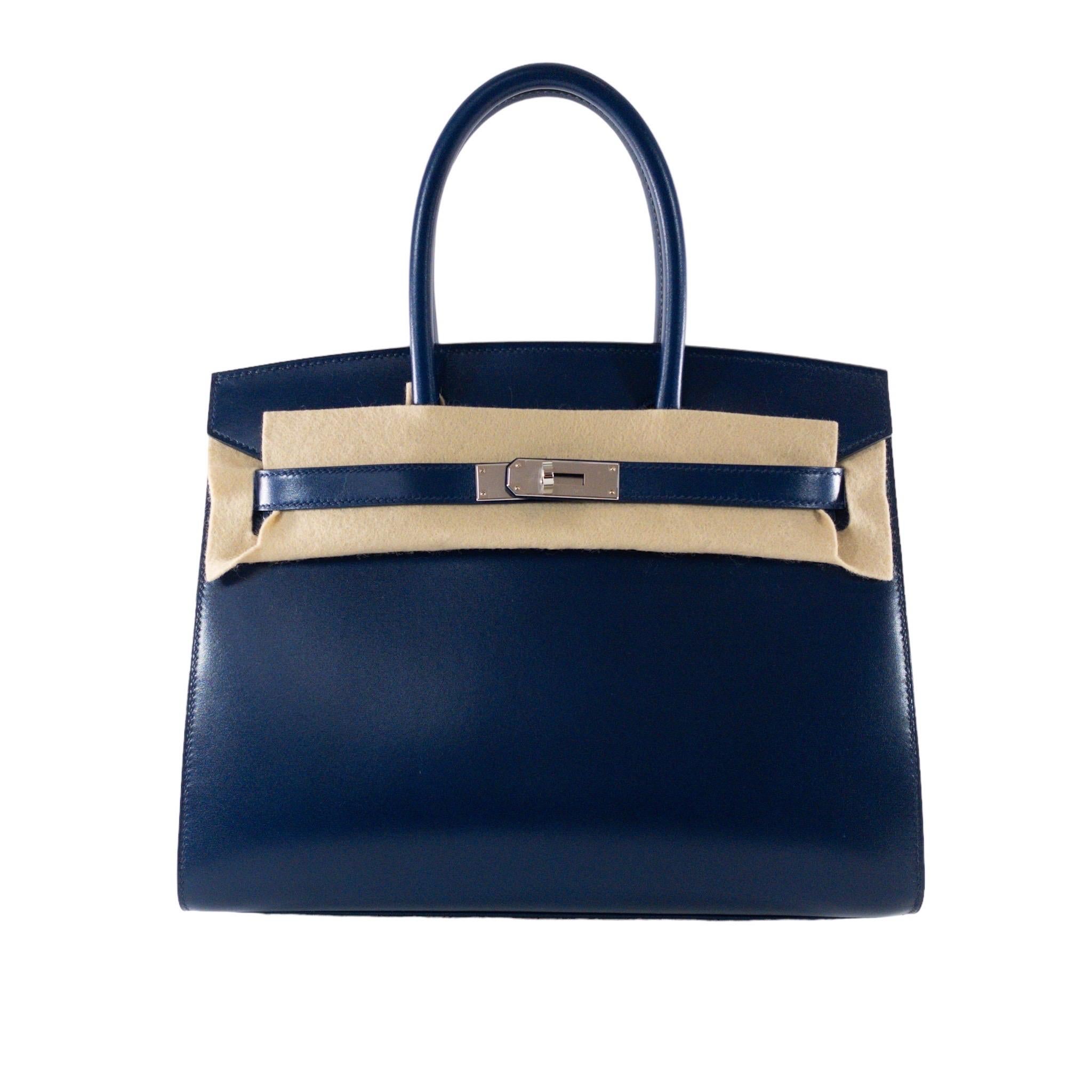 Consign of the Times presents this Brand new in box authentic Hermes Birkin Sellier 30cm in Blue Sapphire Box leather and Palladium hardware. This bag features double rolled top handles with short flap closure. Opens with two leather straps and