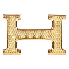 Hebilla de cinturón Hermès "Guillochée" nueva a estrenar  en metal dorado brillante 