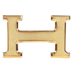 Brand new Hermès "Guillochée" belt buckle in shiny gold metal