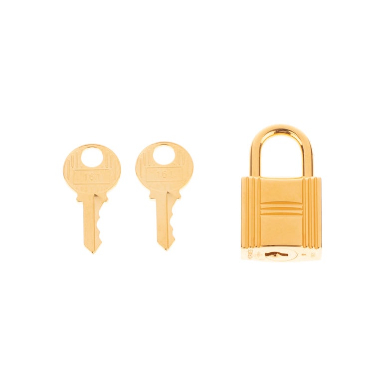 Hermès gold-plated metal padlock for Birkin and kelly bags in gold metal hardware with two keys
Signature: Hermès
Dimensions:  3.5 x 2 x 2 cm ( 1.4 x 0.8 x 0.8 Inches)

New condition under plastic with 2 keys