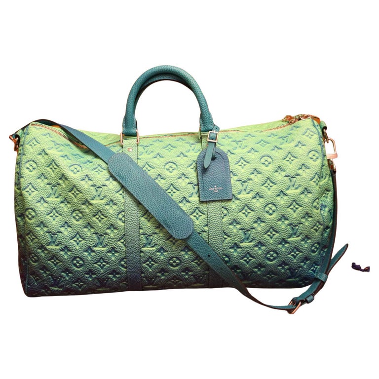 This extraordinary Louis Vuitton Keepall 50 has got very unique color gradient in fluorescent finish. When you look at it, you've got a feeling of an optical illusion with very changing and vivid colors. Made from Virgil Abloh’s new Taurillon