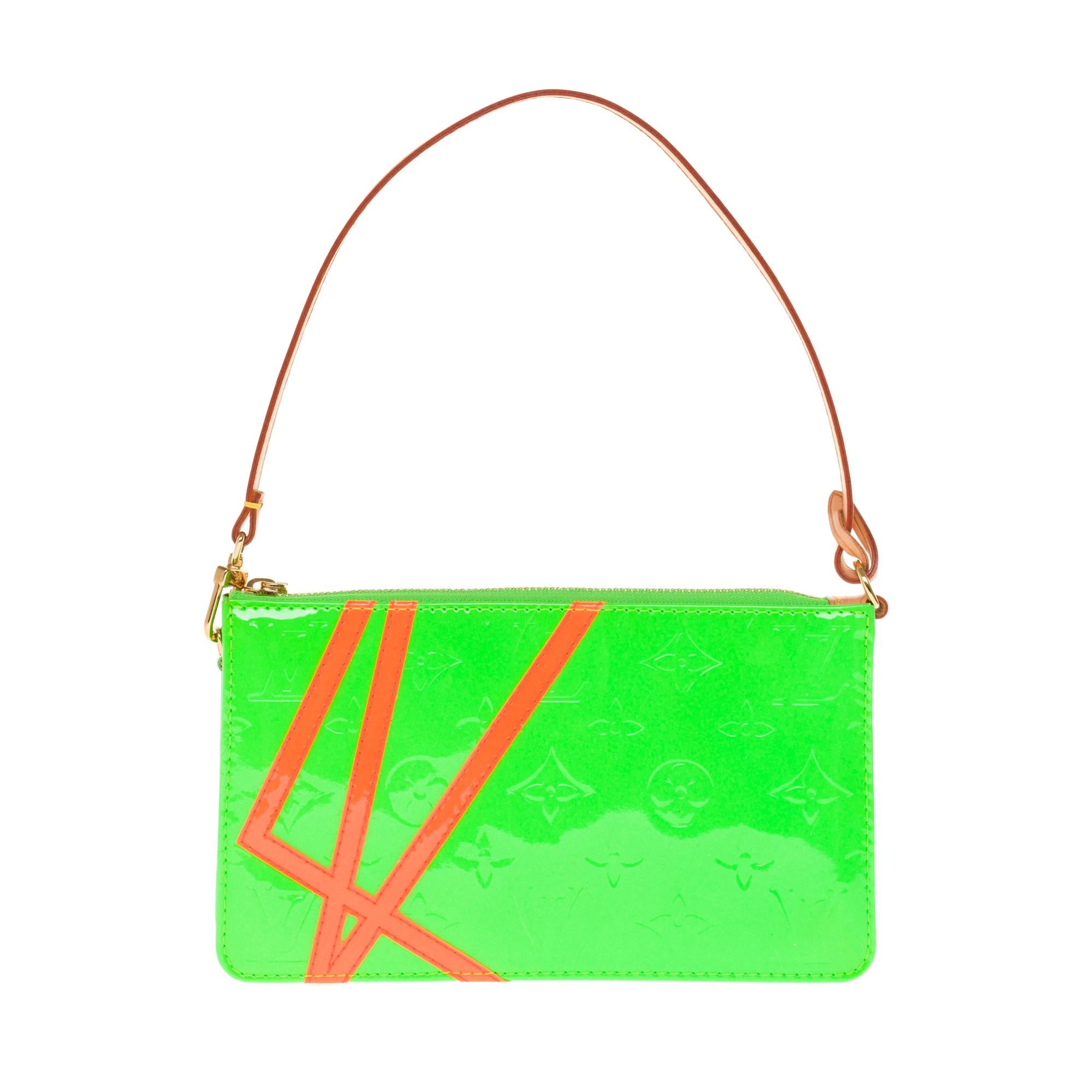 SOLD OUT- Unavailable

The Pochette Lexington designed by Robert Wilson is made of apple green patent leather with orange neon stripes, zip top closure and removable cowhide leather handle.
Signature: 