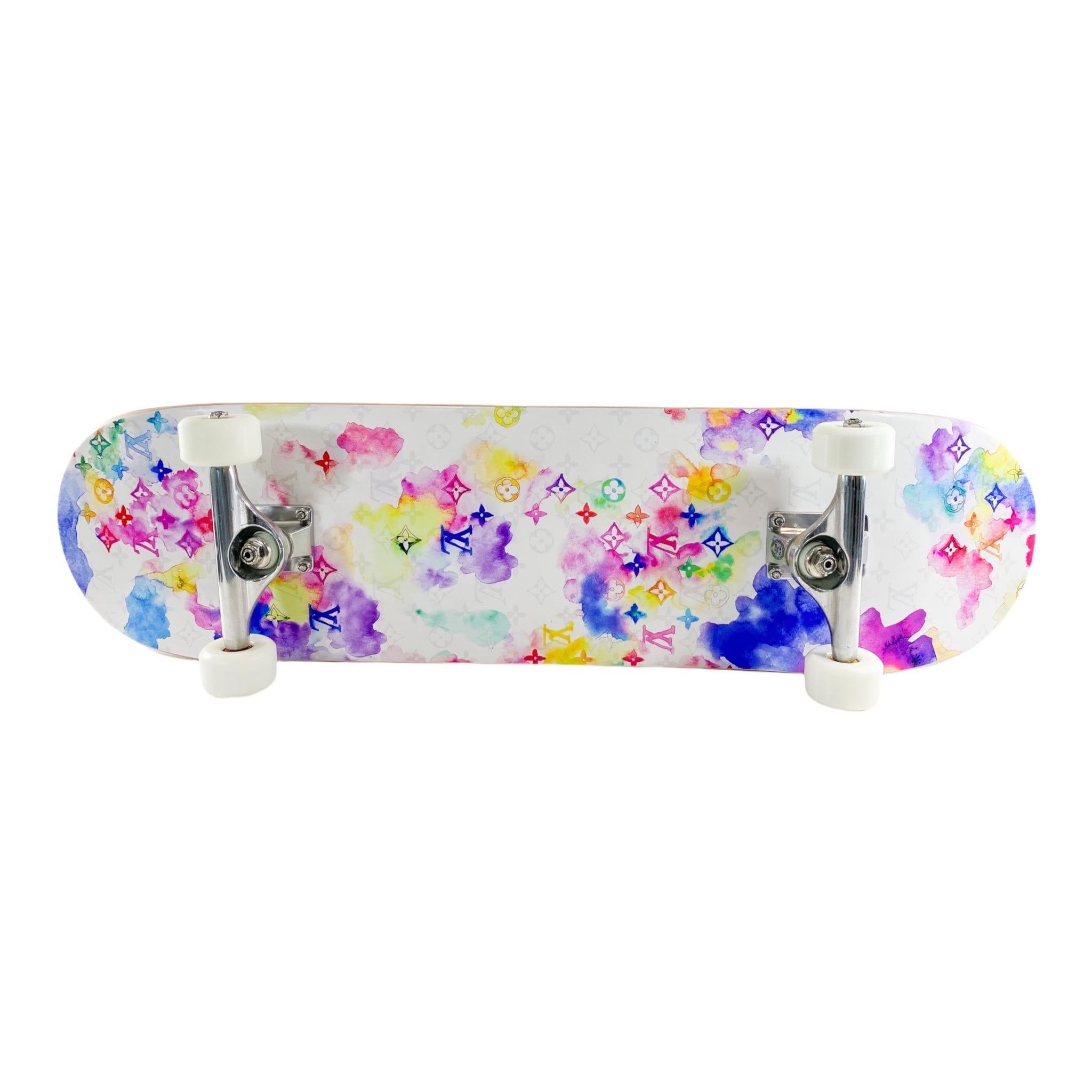 Consign of the Times presents this brand new authentic Louis Vuitton Water Color Skateboard. This skateboard features watercolor print on top with the Louis Vuitton monogram on the bottom. The four wheels all have the Louis Vuitton logo