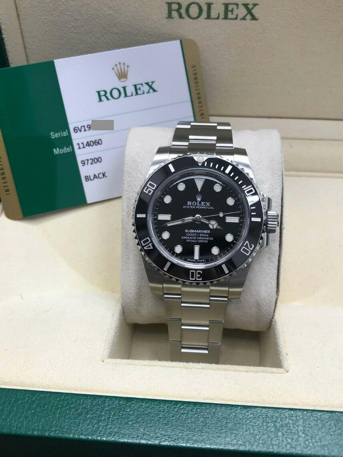 Style Number: 114060

Serial: 6V19E***

Year: 2019

Model: Submariner

Case Material: Stainless Steel

Band: Stainless Steel

Bezel: Black Ceramic

Dial: Black

Face: Sapphire Crystal 

Case Size: 40mm

Includes: 
-Rolex Box & Papers
-Certified