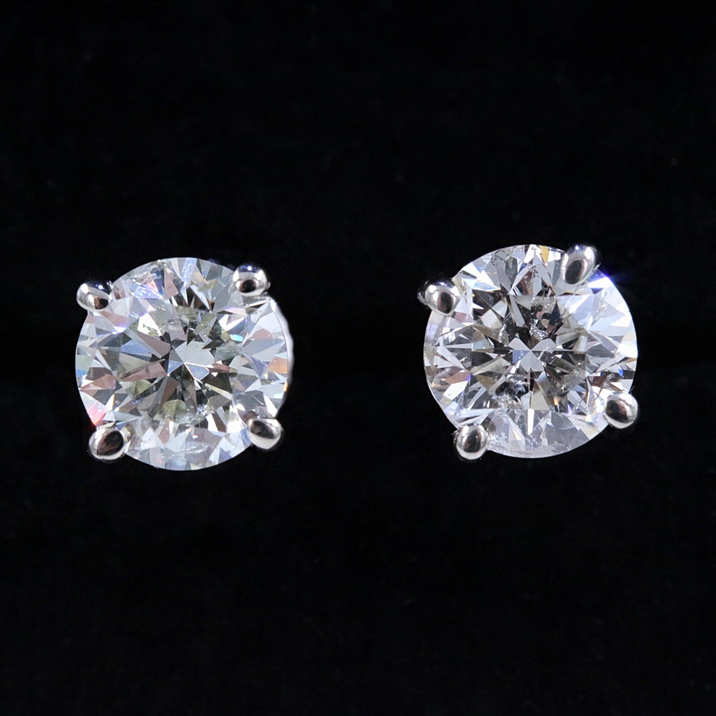 Round Diamond Solitaire Stud Earrings

Style:  Solitaire in 4-Prong Martini Setting with Screw Backs
Metal:  14k White Gold 
Total Carat Weight:  2.05 tcw
Diamond #1:  Round 1.00 cts I color, I1 clarity  
Diamond #2:  Round 1.05 cts I color, I1