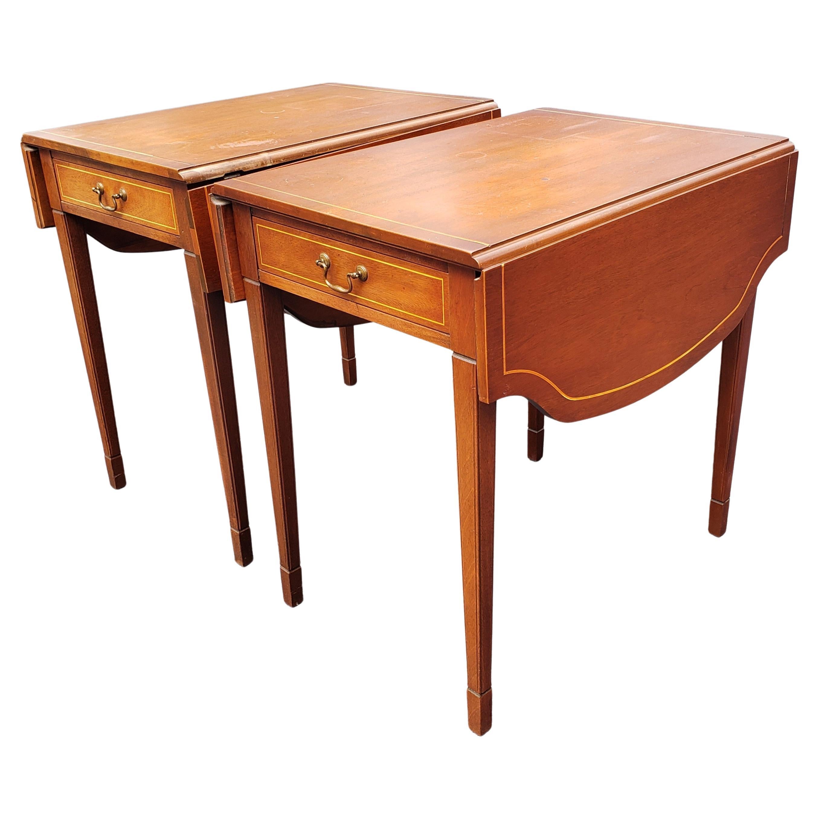 Exquisite pair of Brandt Furniture Certified Genuine Mahogany Pembroke Drop-Leaf Tables from the 1940s. Good vintage condition. 
One functional drawer. Table seems to have been refinished at some point. Some wear appropriate with age and use.