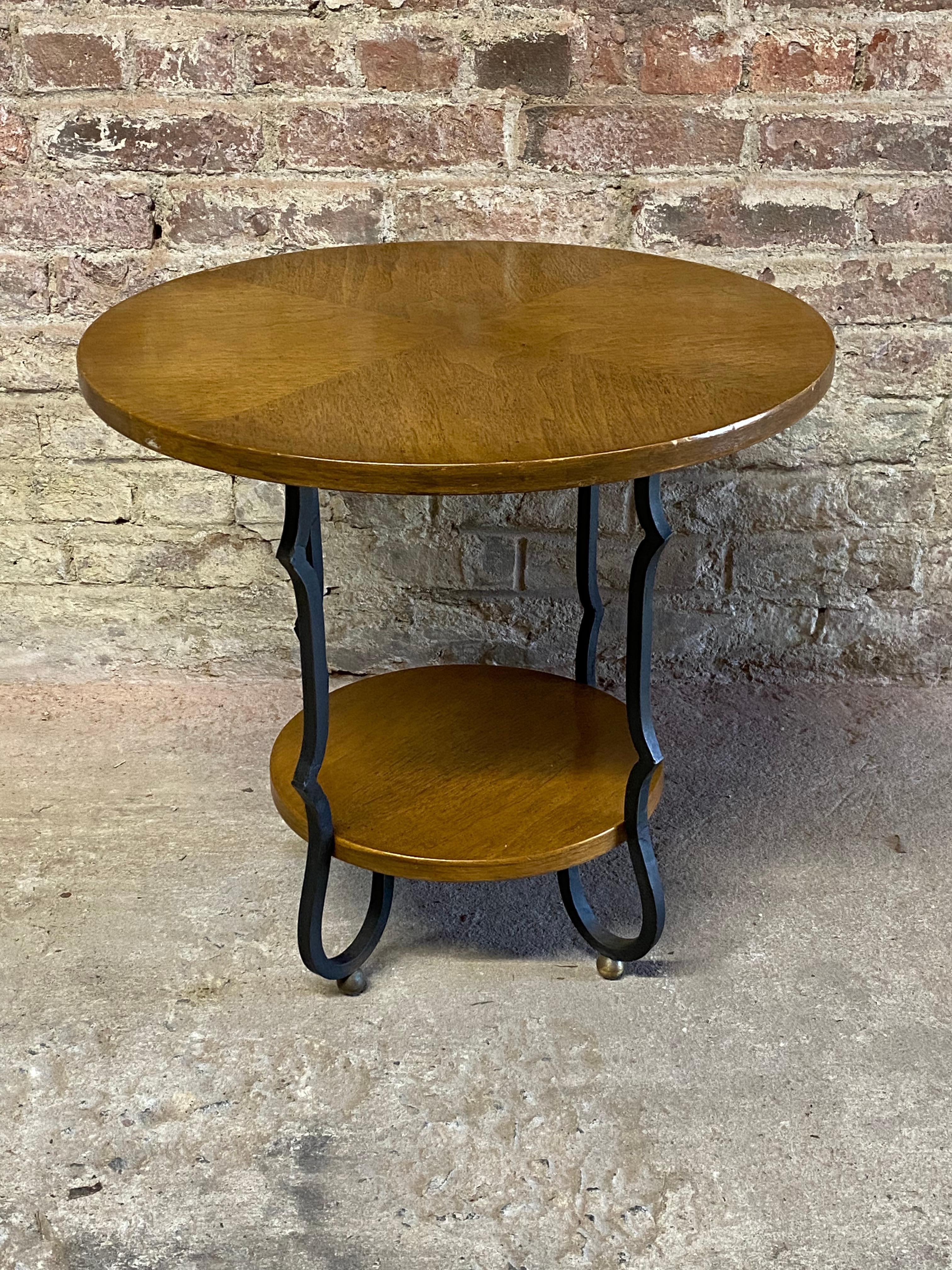Brandt end table featuring cast aluminum ebonized legs and a Pecan finish contrasting wedge shaped veneers. Fully signed on the bottom. Circa 1950-60. 

Good overall condition with minor finish losses and fine scratches. Wear commensurate with age
