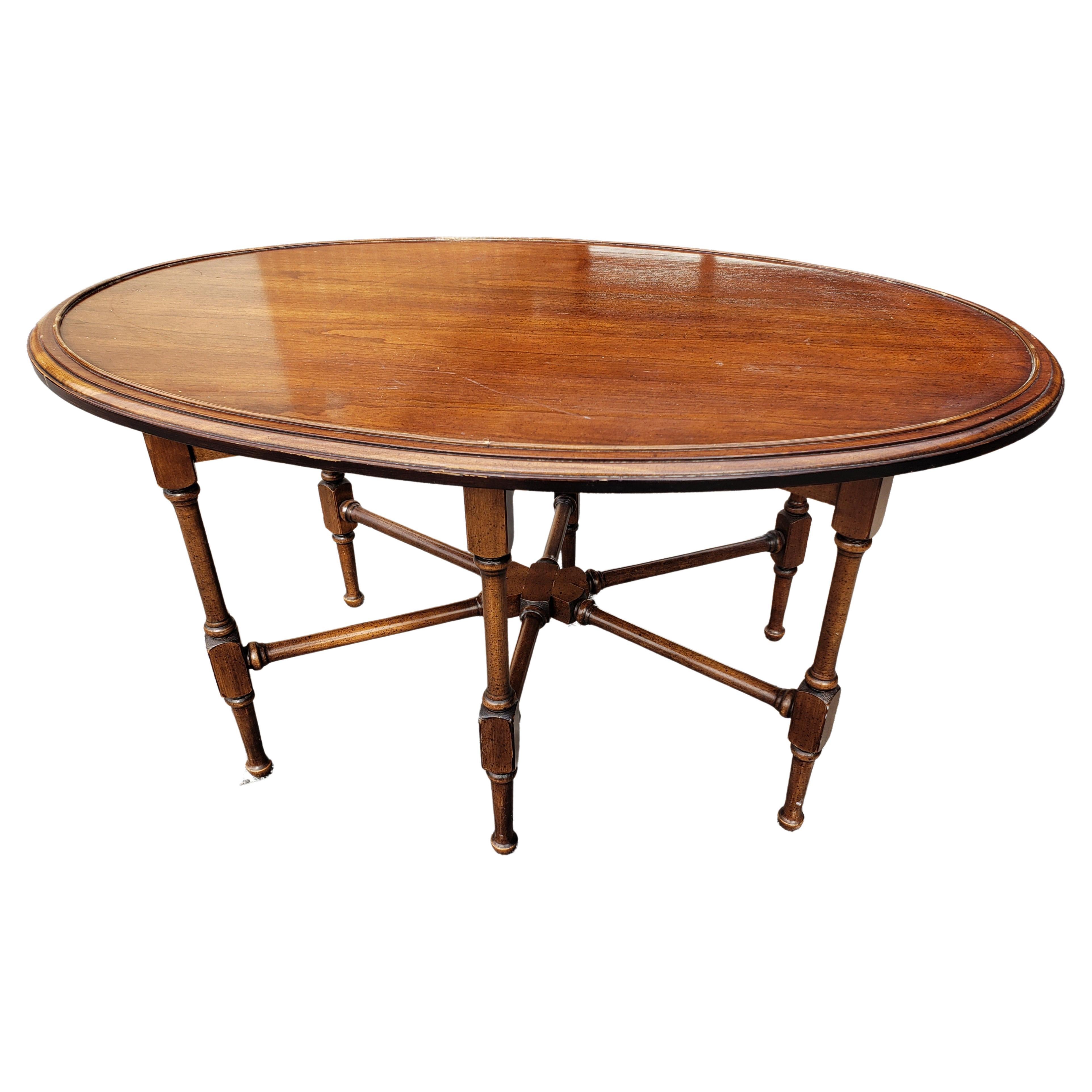 Brandt furniture faux bamboo mahogany oval coffee table, Circa 1960s. 6 legs joined together underneath the table provides uniqueness and greater stability for this table
 Measures 35