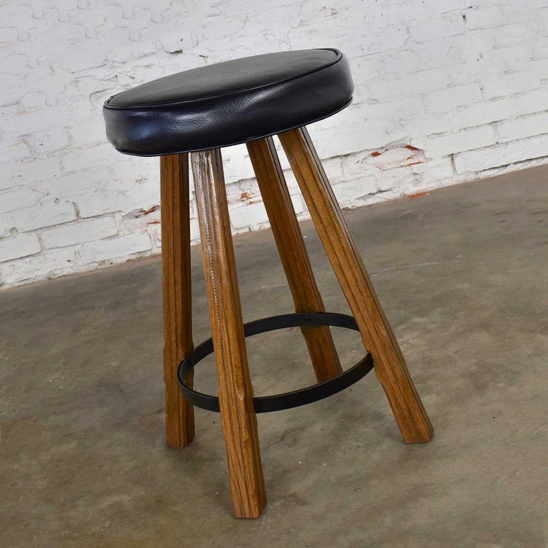 Beautiful swivel bar stool by A. Brandt comprised of solid ranch oak and a dark brown almost black vinyl or faux leather seat cushion. Wonderful vintage condition. The joints have been tightened and the swivel lubricated, and a light coat of