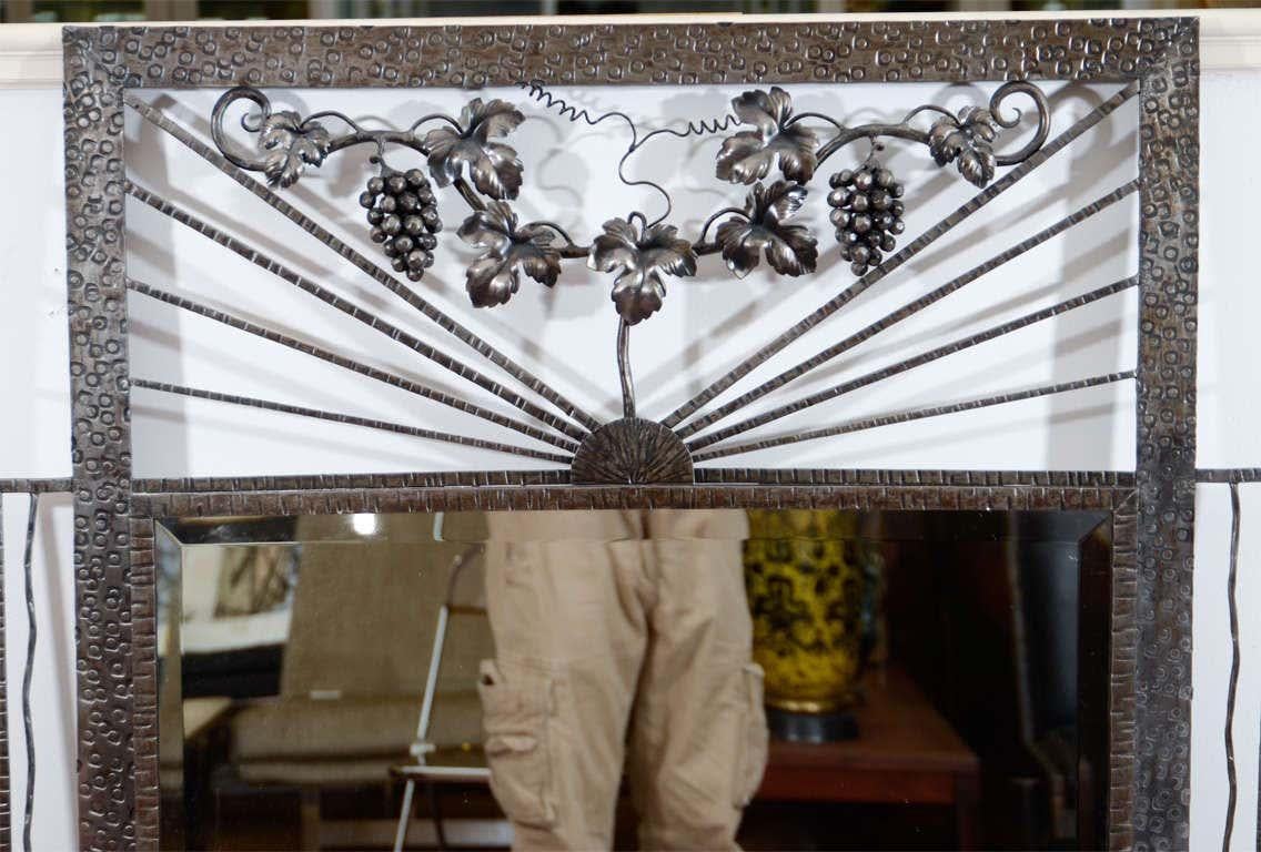Edgar Brandt style Art Deco mirror surrounded by a worked iron frame, decorated with a grape vine with grapes and leaves. Measures: 55