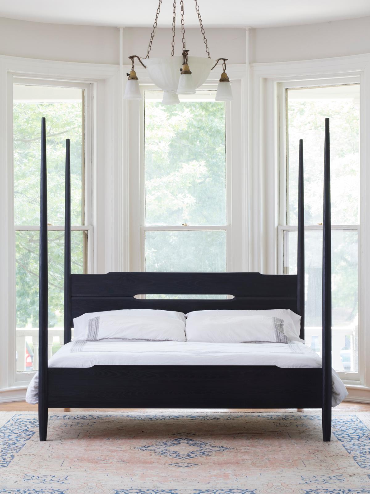 A classic American bed form rooted in its Shaker tradition with modern Danish touches. Its hand planed faceted posts and carved accents mark its handmade character up close. After much development, its joinery design allows for both a clean