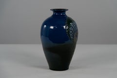 Brannam of Barnstaple. A rare blue vase decorated with a squirrel eating nuts.