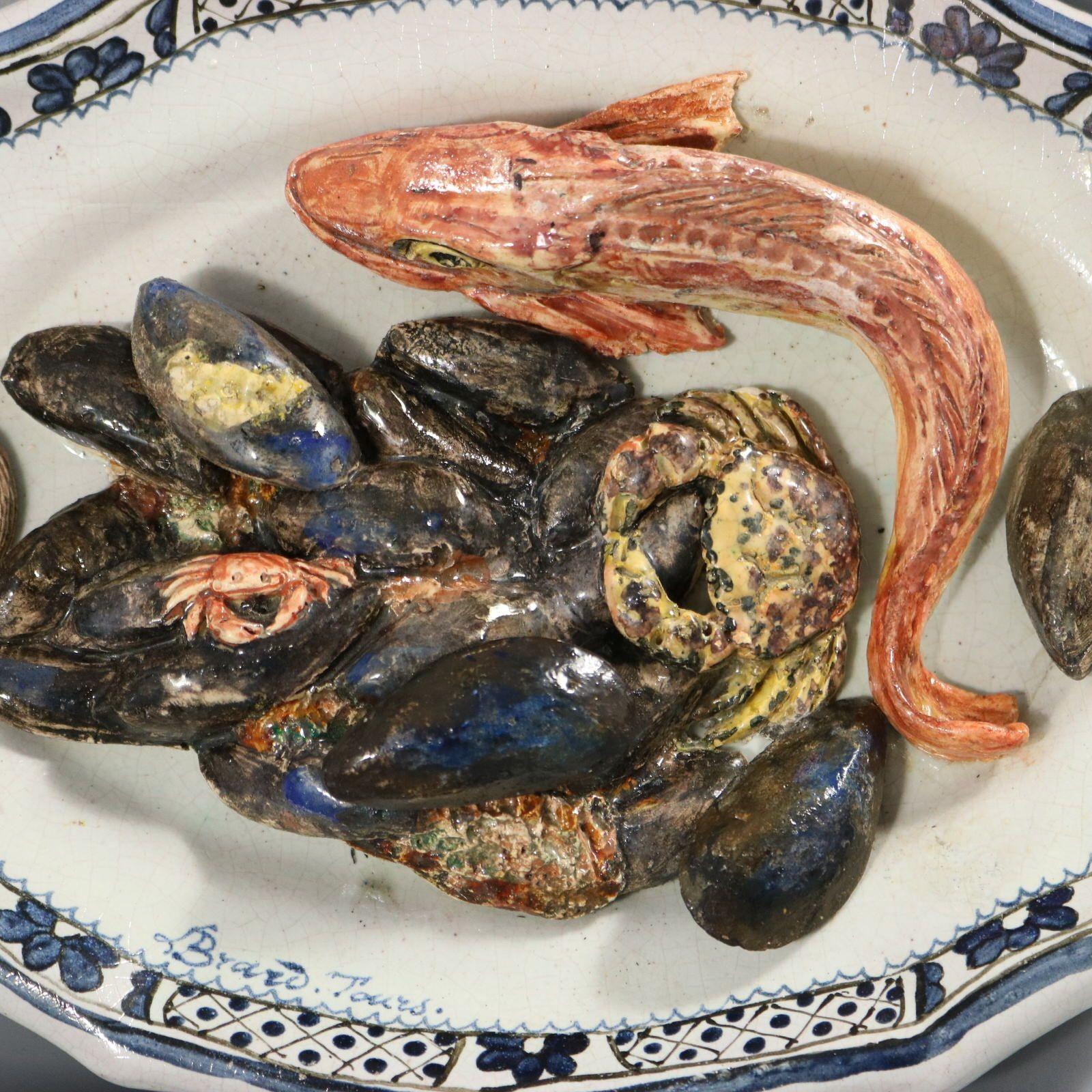 Brard French Palissy Majolica wall platter which features a fish (red mullet) a pile of mussels on a rock, with two crabs and a clam shells. Colouration: white, blue, pink, are predominant. The piece bears maker's marks for the Brard pottery.