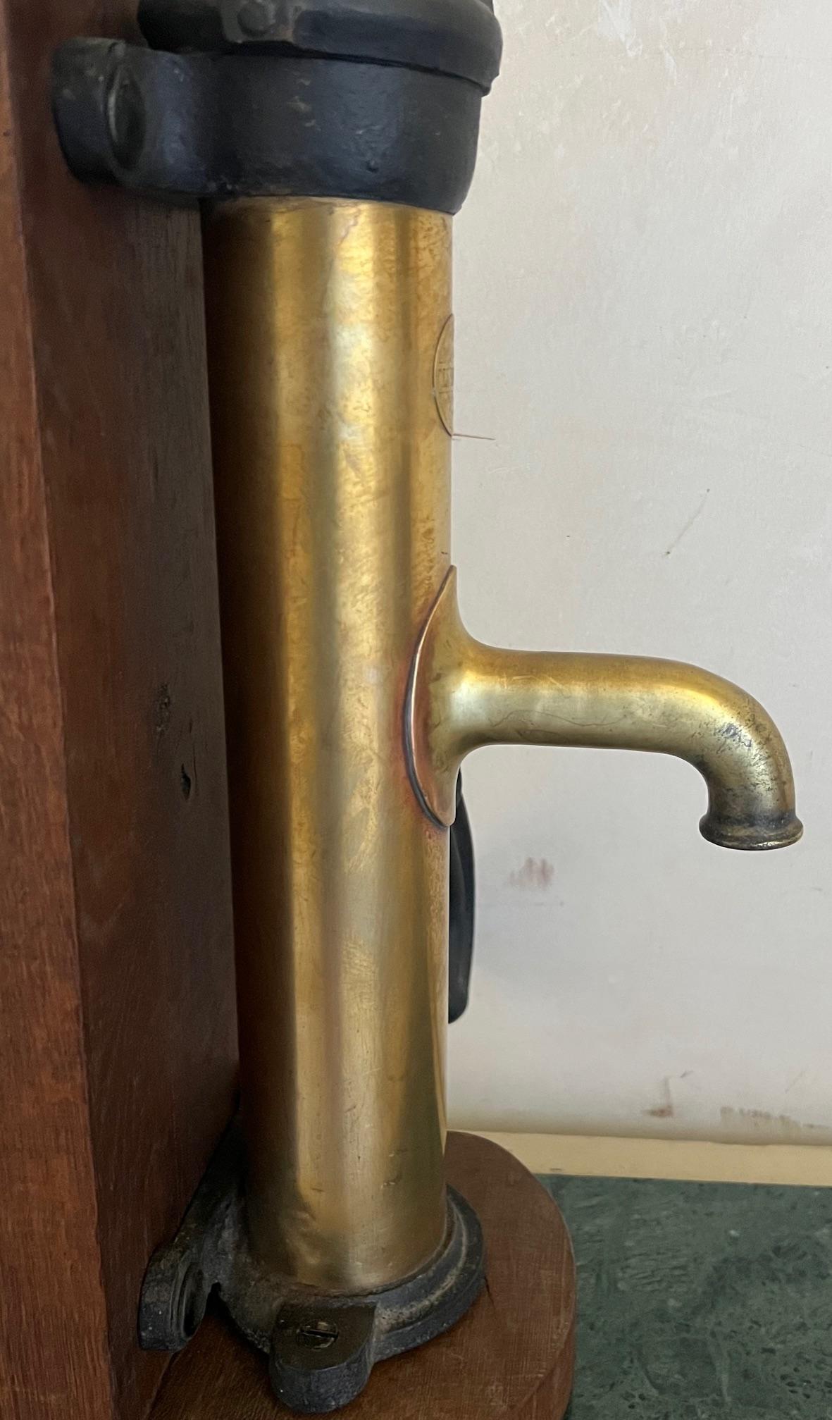 Early 20th Century Brass and Cast Iron Antique Pump and Spout Mounted on Wood, c. 1900 For Sale