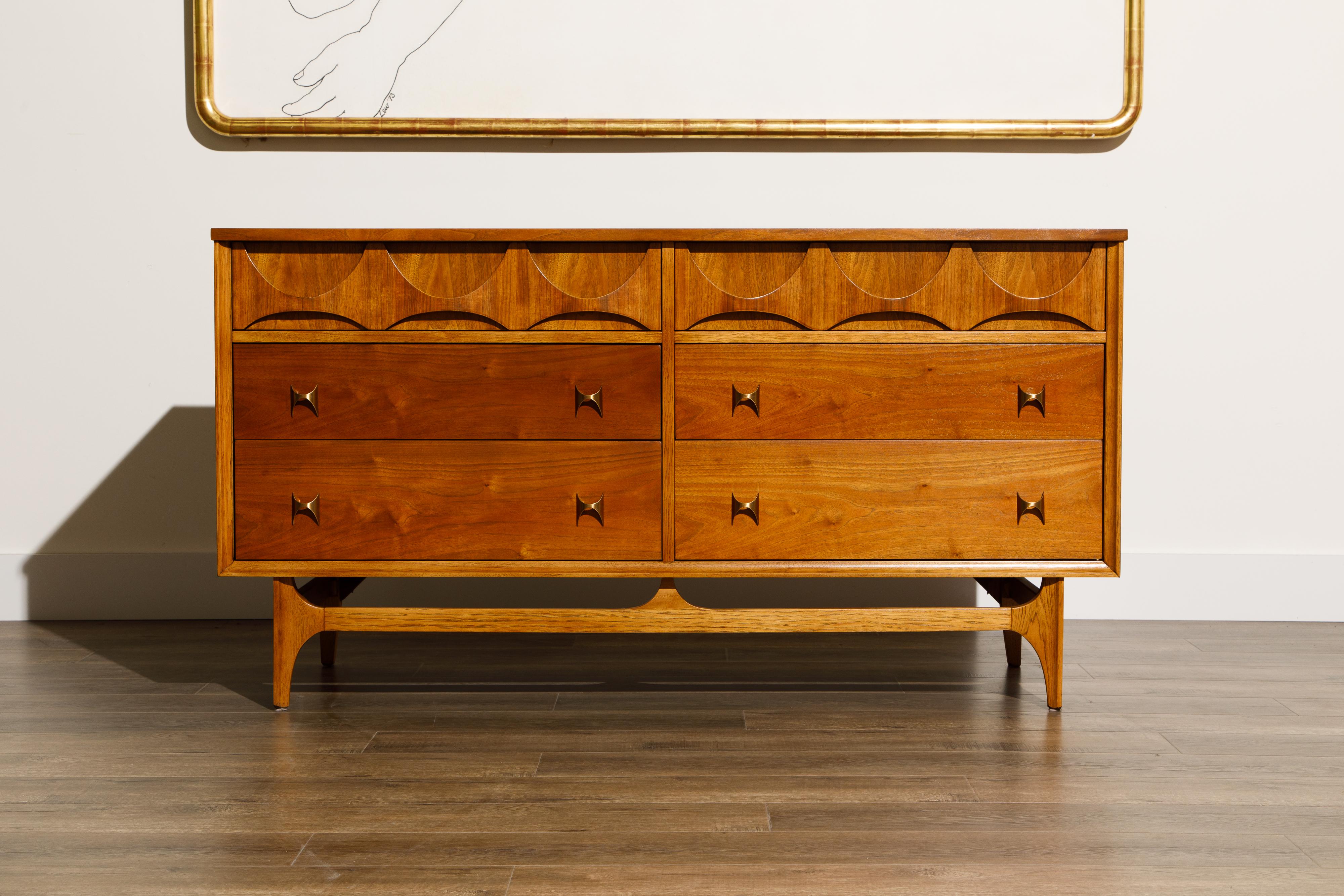 This incredible pairing of a 'Brasilia' by Broyhill Premiere dresser and mirror have been completely refinished and is signed with its original Brasilia label, and ready to grace your home or office. This beautiful dresser features the signature