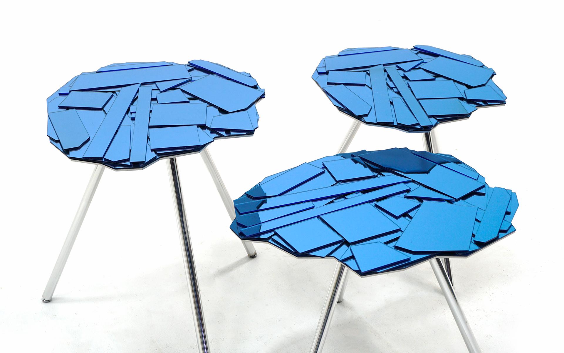 Ensemble de trois tables Brasilia conçues par Fernando et Humberto Campana pour Edra, Italie, 2006. Plateaux en verre Reflex miroité de couleur bleue et pieds en aluminium chromé. Les éclats de verre sont montés sur une plaque d'aluminium découpée