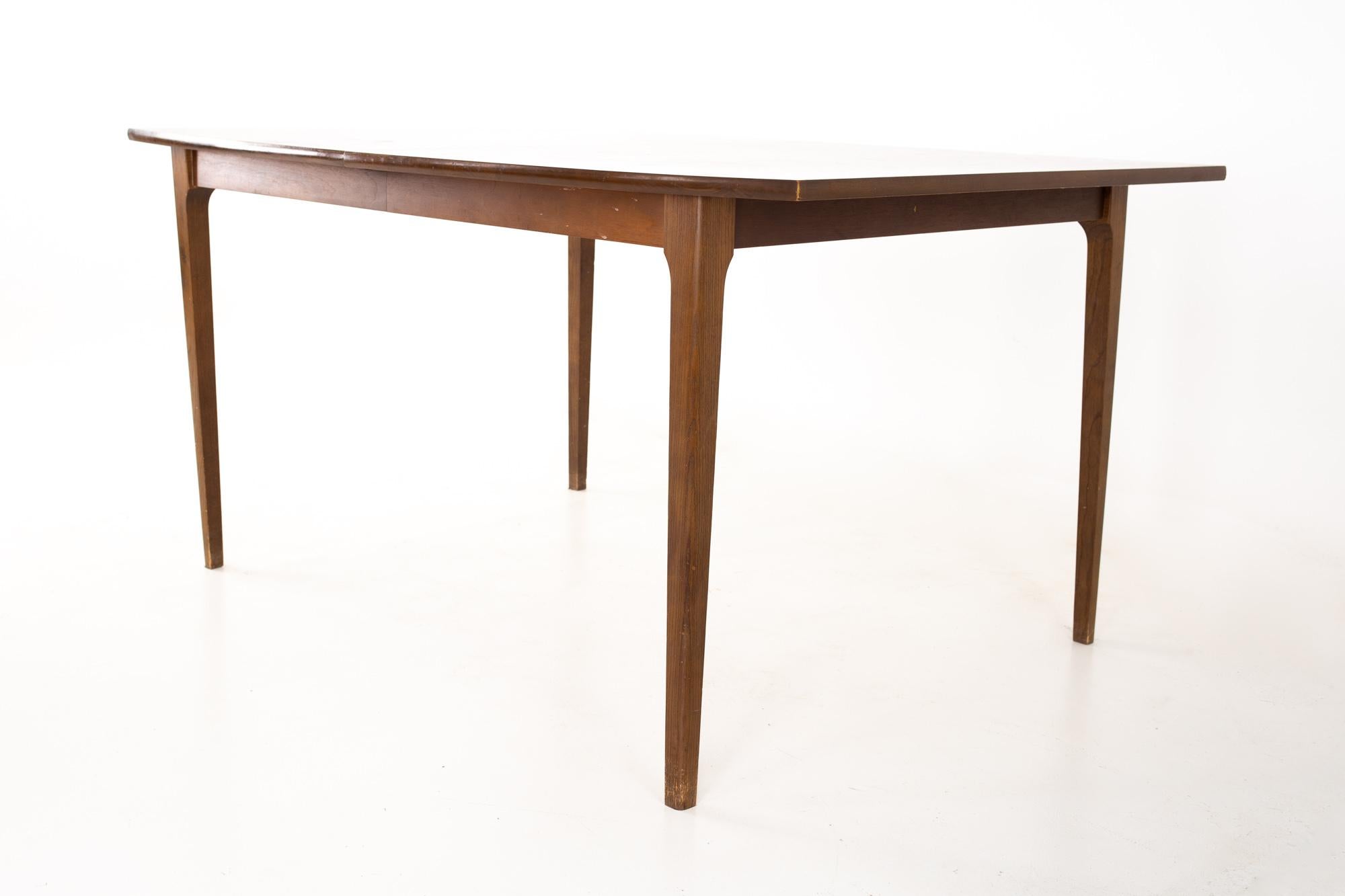 Brasilia style mid century walnut surfboard dining table with 2 leaves
Table measures: 59 wide x 40 deep x 29.5 high, with a chair clearance of 26 inches, Each leaf measures 12 inches wide 

All pieces of furniture can be had in what we call