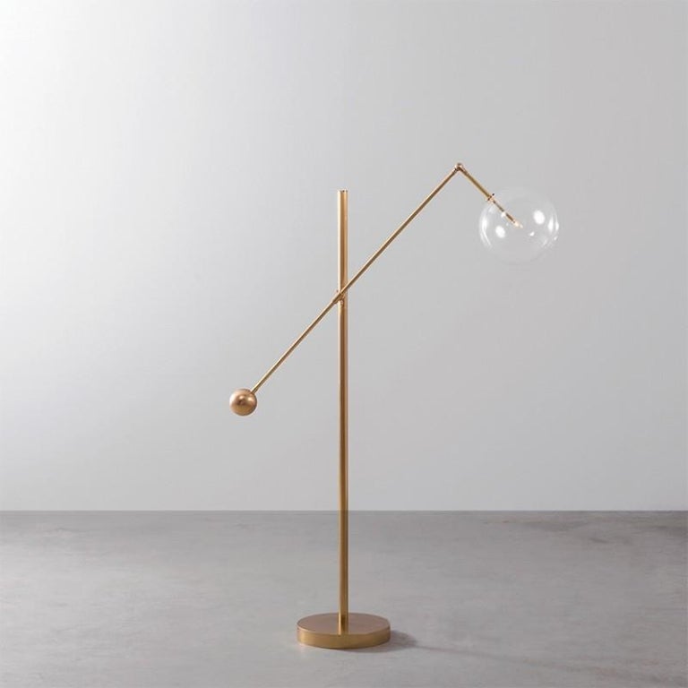 Brass 1 arm floor lamp by Schwung
Dimensions: D 33.2 x W 114.3 x H 145.4 cm
Materials: Solid brass, hand-blown glass globes
Finish: Natural Brass. 
Available in finishes: Black Gunmetal or Polished Nickel. Also available in Table Lamp. 
All our