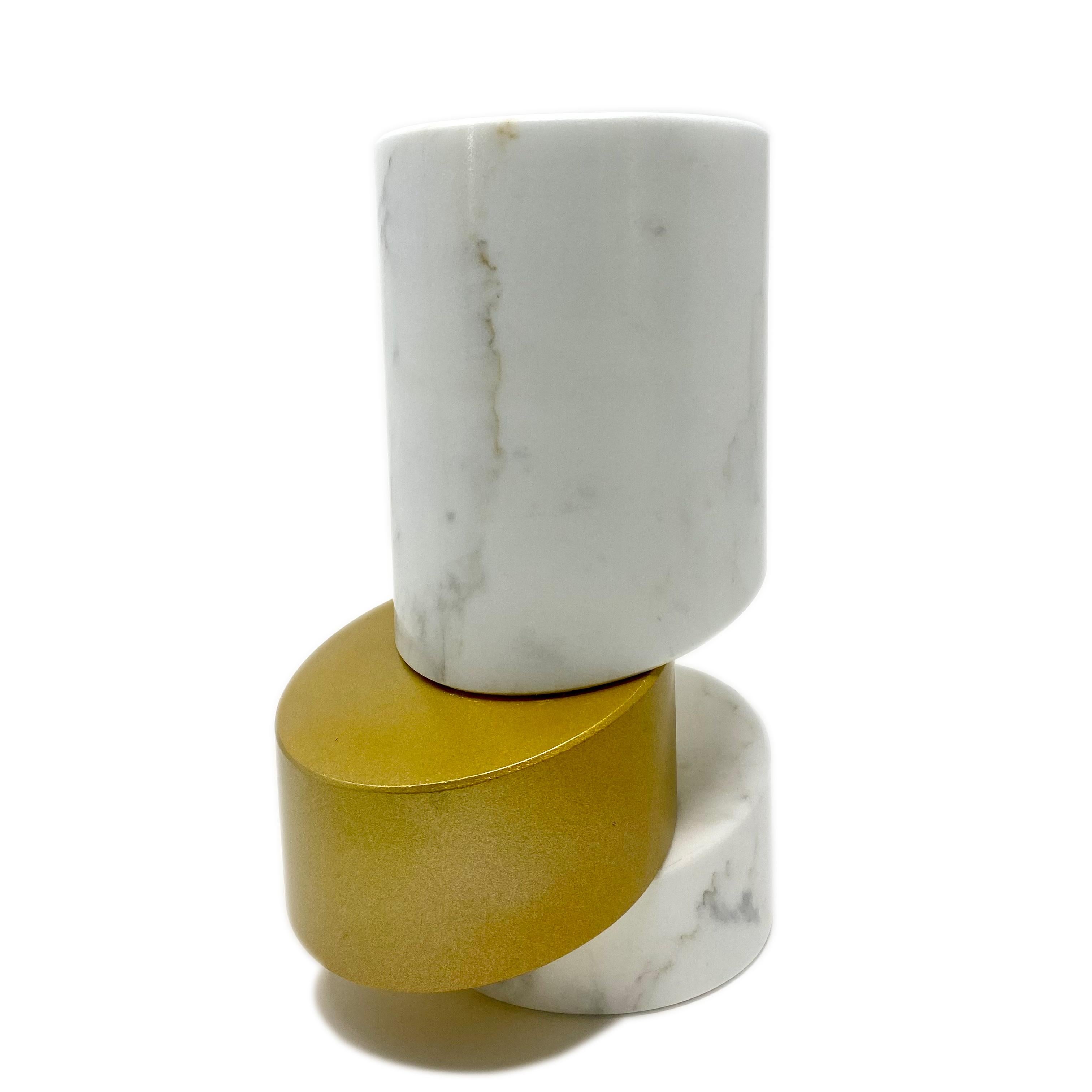 The Brass Vase, entirely made of marble, is an exclusive vase in Calacatta Oro composed of three blocks of marble placed one above the other in an asymmetrical way. The central section is embellished with a gold finish, giving the Brass vase an