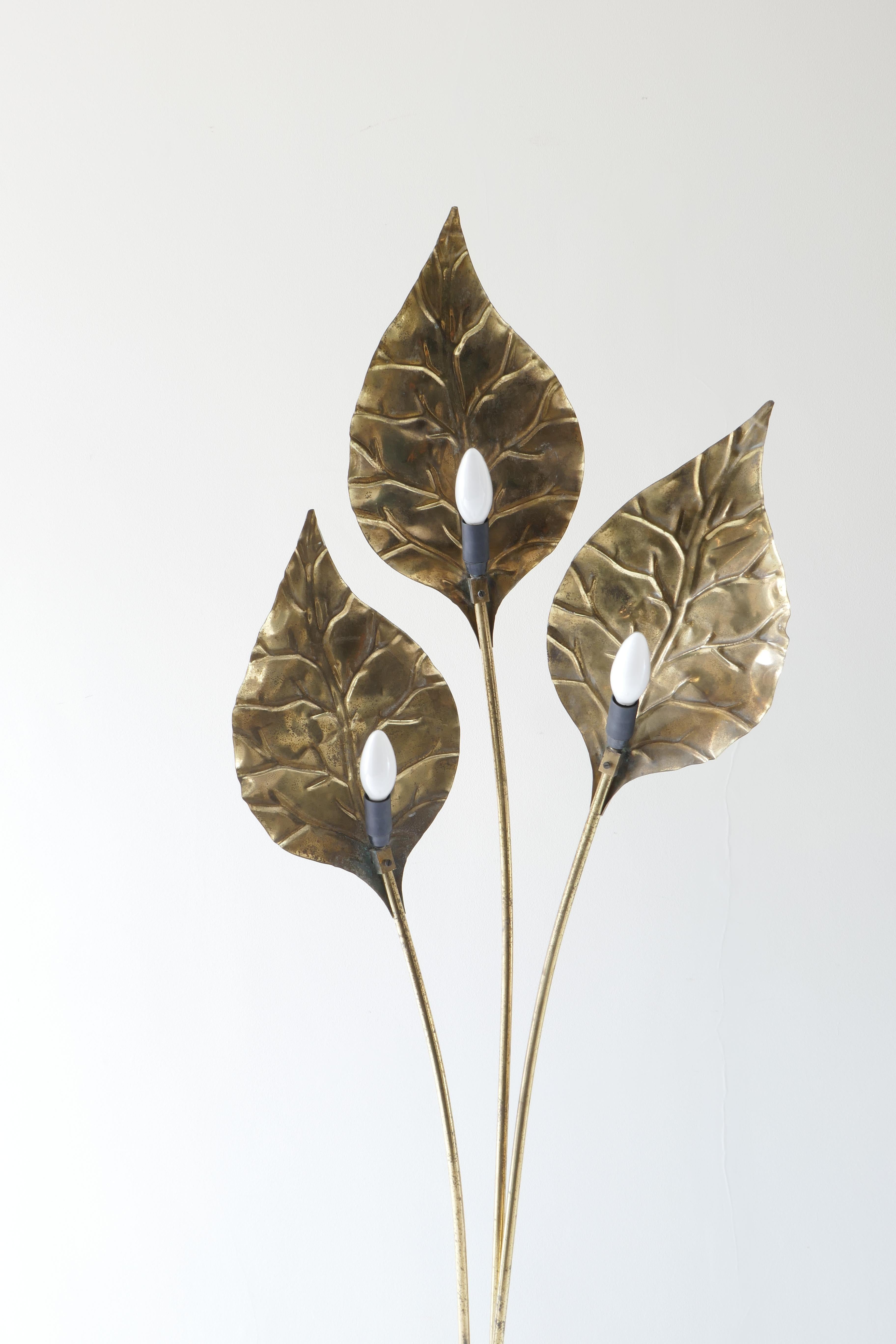 A unique brass 3 leaves floor lamp with a round 30cm base.
Each leaf hides a bulb in the back 
In style of Tommaso Barbi Leaf lamps this floor lamp is also Italian from 1970s.
The floor lamp has been rewired to UK standards. Nice vintage patina