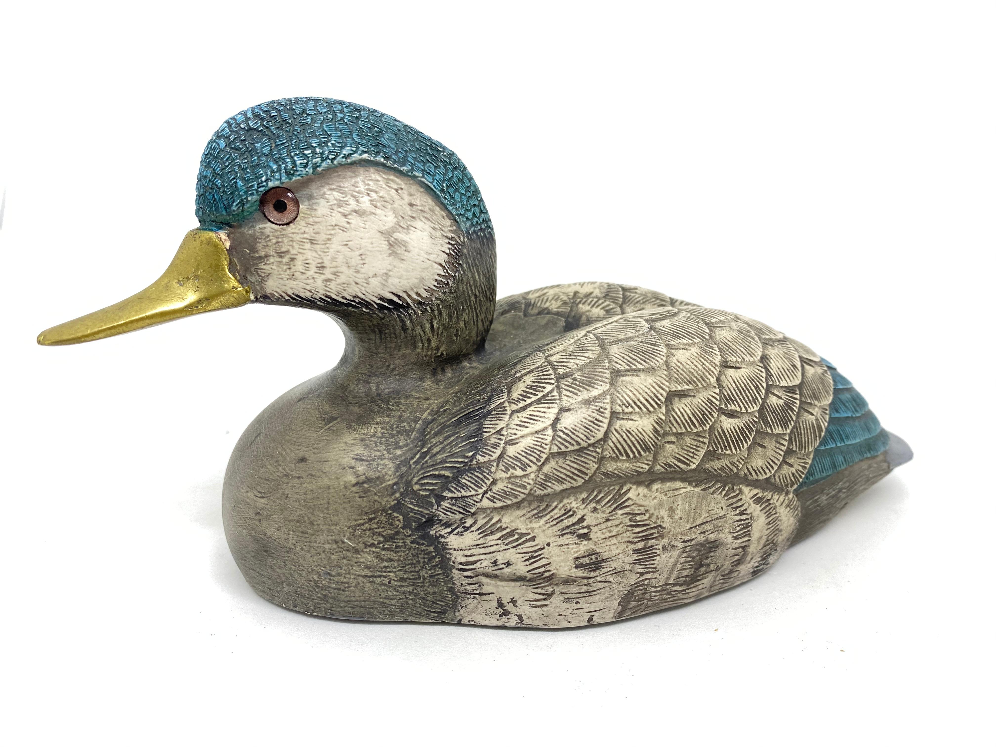 Vintage signed duck figurine by Elli Malevolti. It features a decoy type design with brass accented parts. It has glass eyes and a hand painted body. A nice addition to the Hollywood Regency interior. Signed Malevolti Italy.