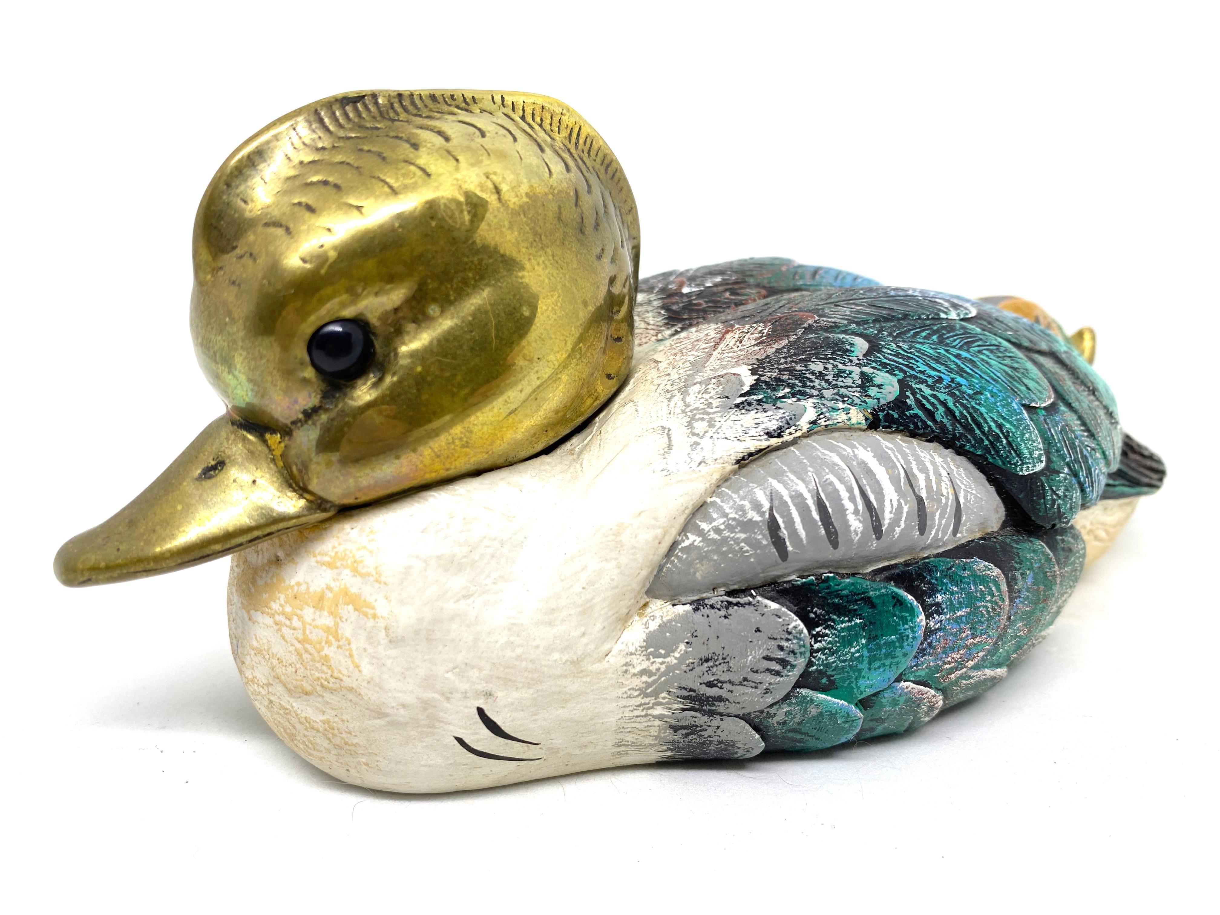 Vintage signed duck figurine by Elli Malevolti. It features a decoy type design with brass accented parts. It has glass eyes and a hand painted body. A nice addition to the Hollywood Regency interior. Signed Malevolti, Italy.