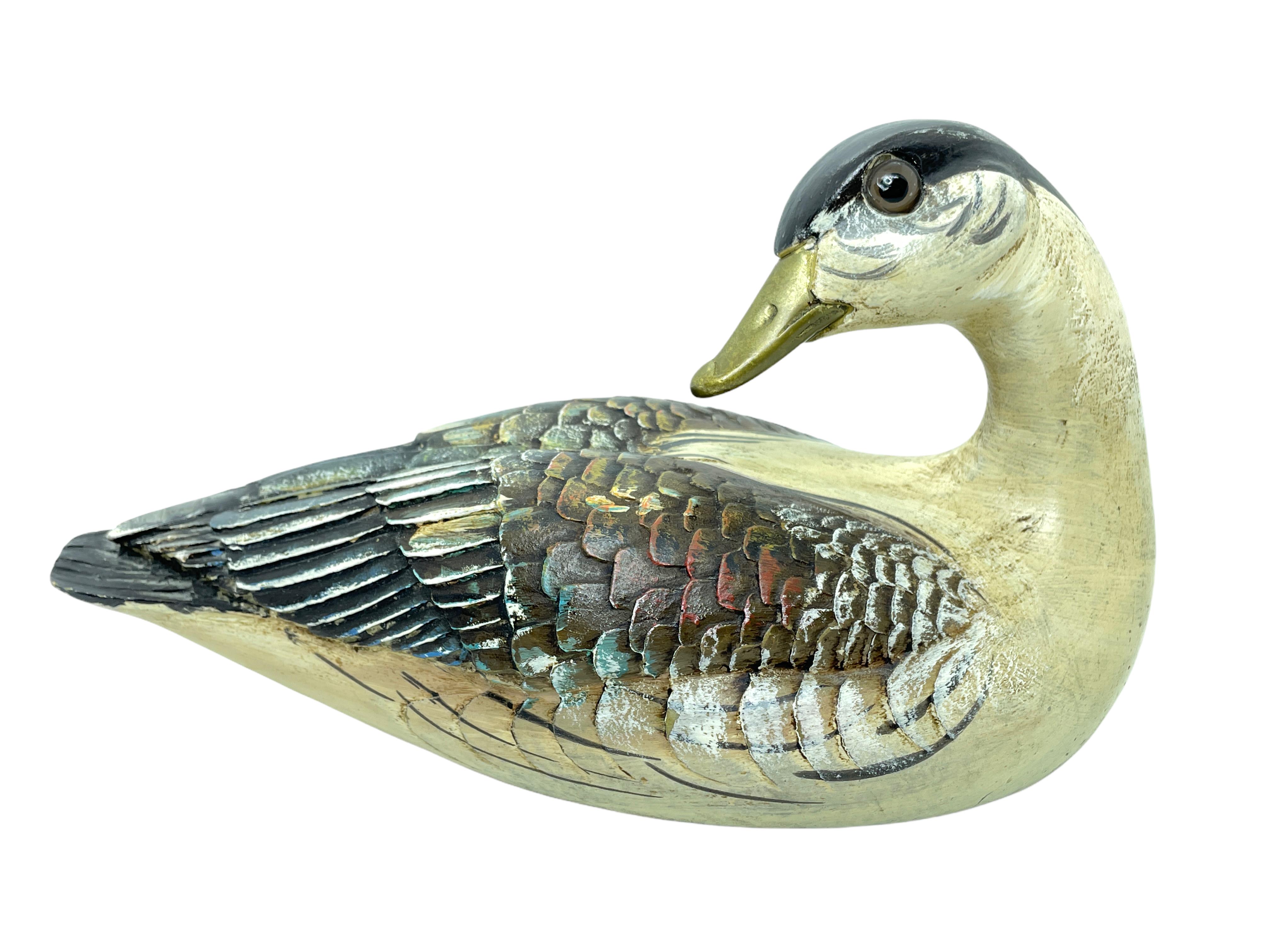 Vintage signed duck figurine by Malevolti, Italy. It features a decoy type design with brass accented parts. It has glass eyes and a hand painted body. A nice addition to the Hollywood Regency interior. Signed Malevolti Italy.