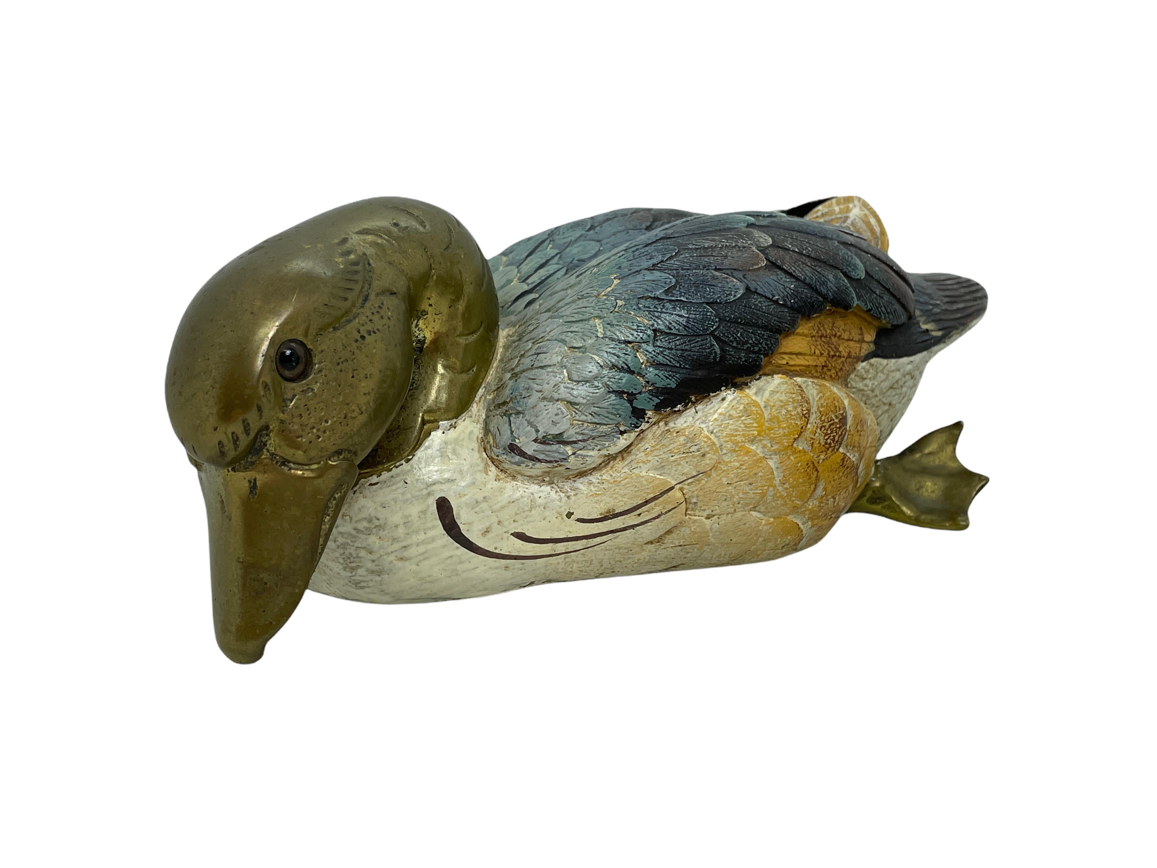 Vintage signed duck figurine by Malevolti, Italy. It features a decoy type design with brass accented parts. It has glass eyes and a hand painted body. A nice addition to the Hollywood Regency interior. Signed Malevolti Italy.