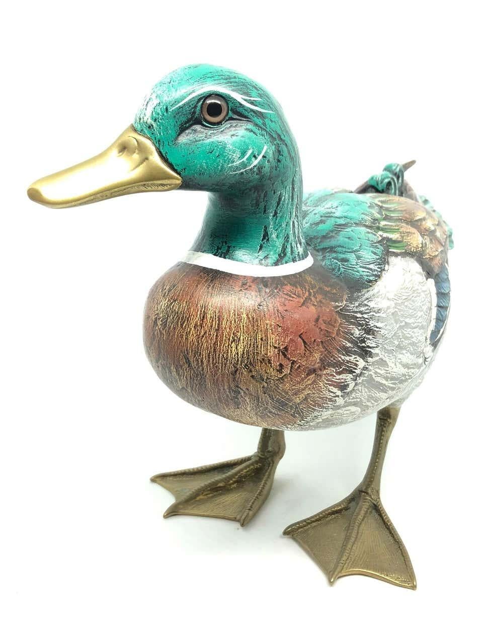 Vintage signed duck figurine by Elli Malevolti. It features a decoy type design with brass accented parts. It has glass eyes and a hand painted body. A nice addition to the Hollywood Regency interior. Signed Malevolti Italy. The duck measures