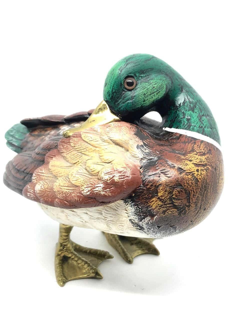 Vintage signed duck figurine by Elli Malevolti. It features a decoy type design with brass accented parts. It has glass eyes and a hand painted body. A nice addition to the Hollywood Regency interior. Signed Malevolti Italy.