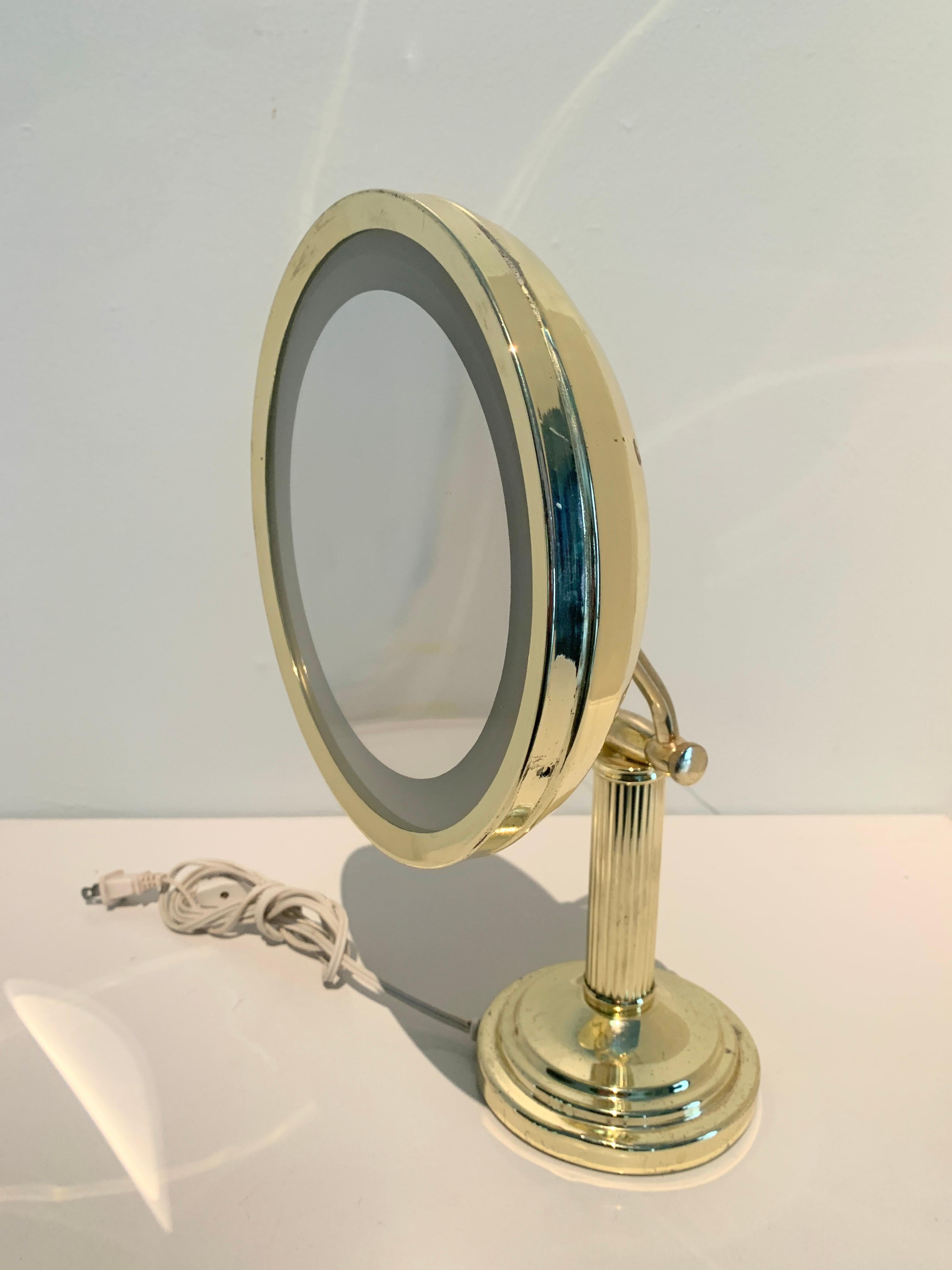 Vanity or Table mirror with lit magnifying mirror - the brass housing and design, allowing the mirror to be adjusted, and tilted are not only a compliment to any dressing room or vanity, but the vintage style makes it a fantastic decorative