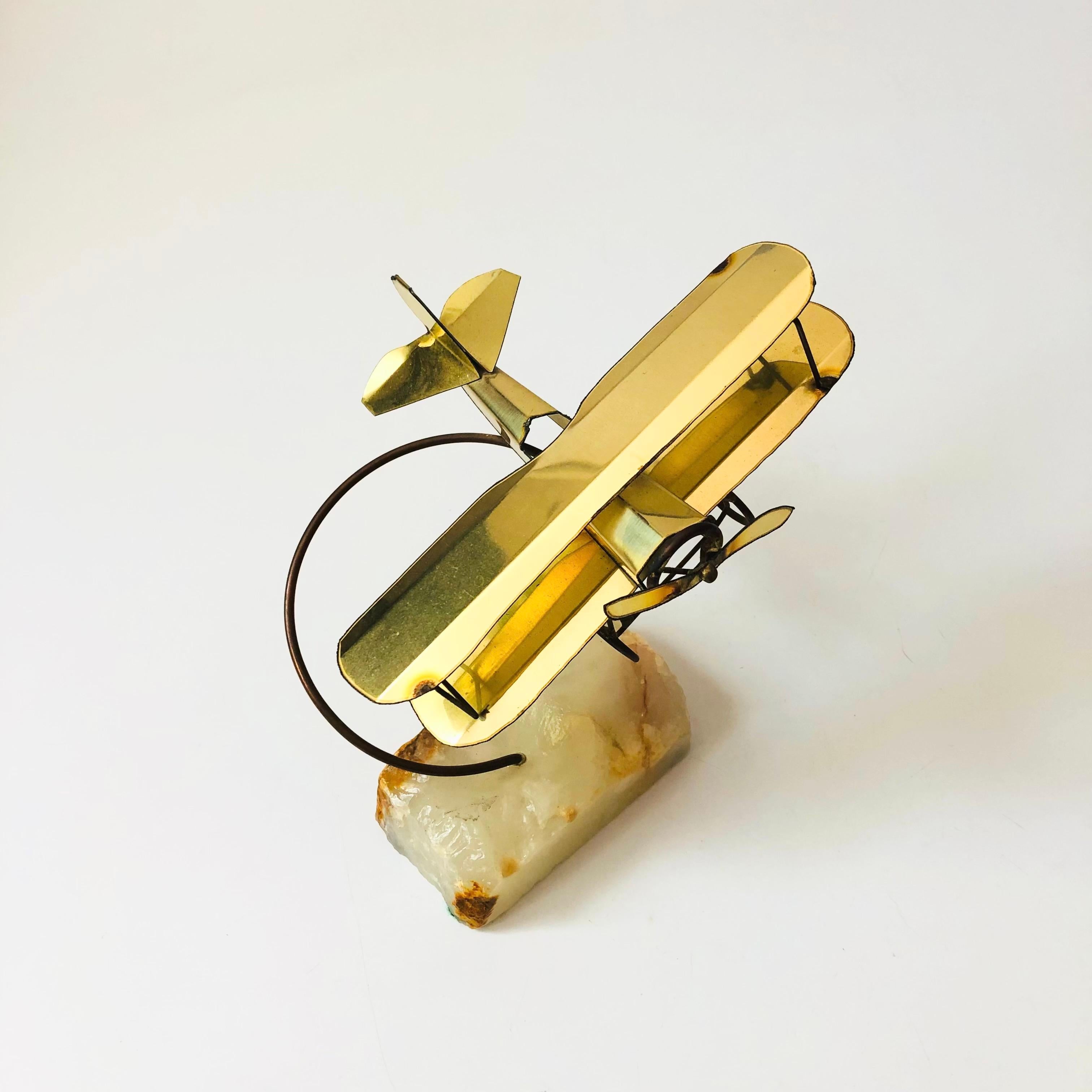 A wonderful vintage biplane sculpture. A Mario Jason Original, made in California, original tag will be attached. Made out of brass sheet metal and affixed to a stone base.


