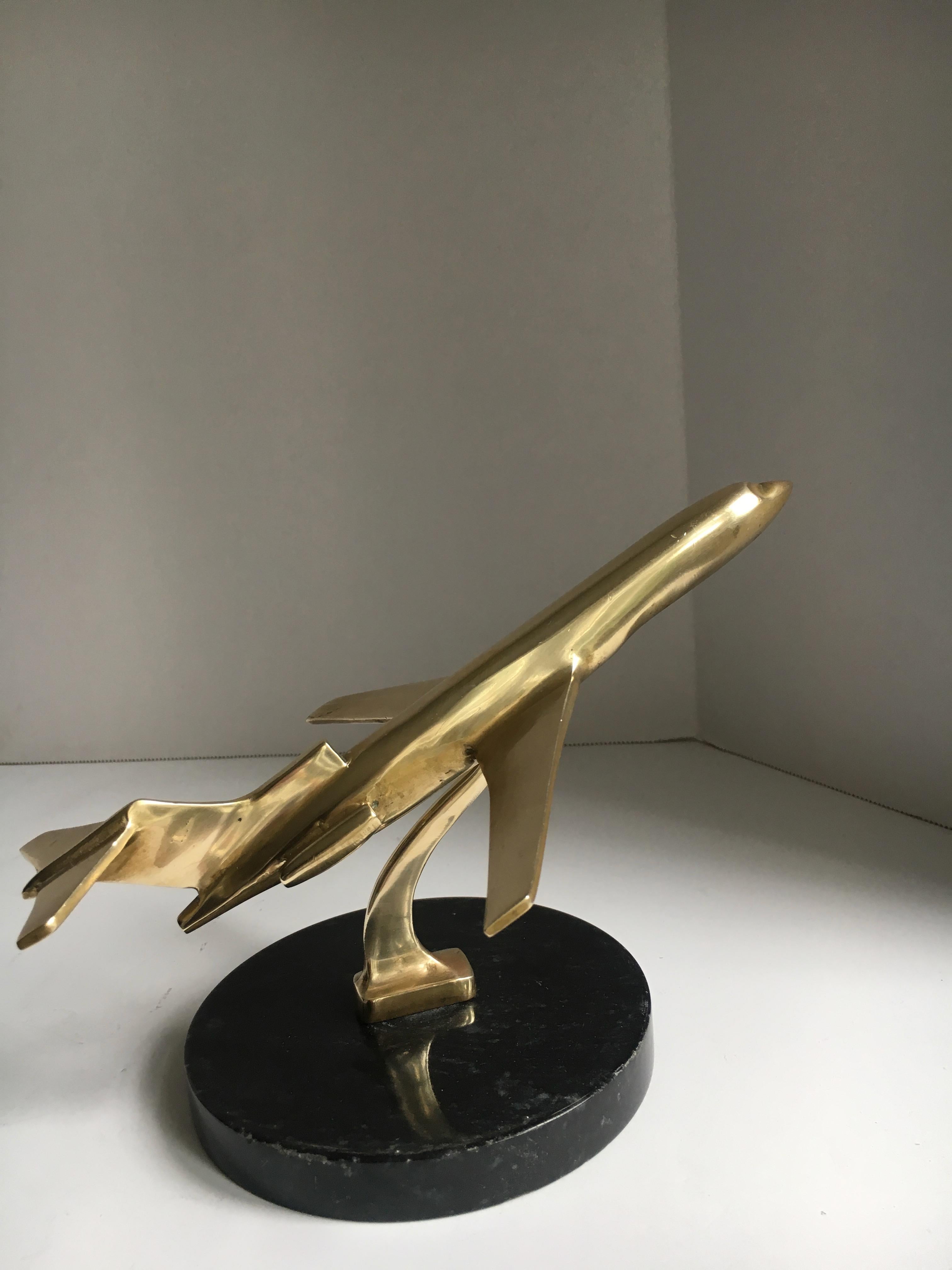 A beautifully crafted solid brass airplane in flight atop a marble base, a wonderful desk accessory or paper weight, perfect for the aviation aficionado, pilot or flight attendant.