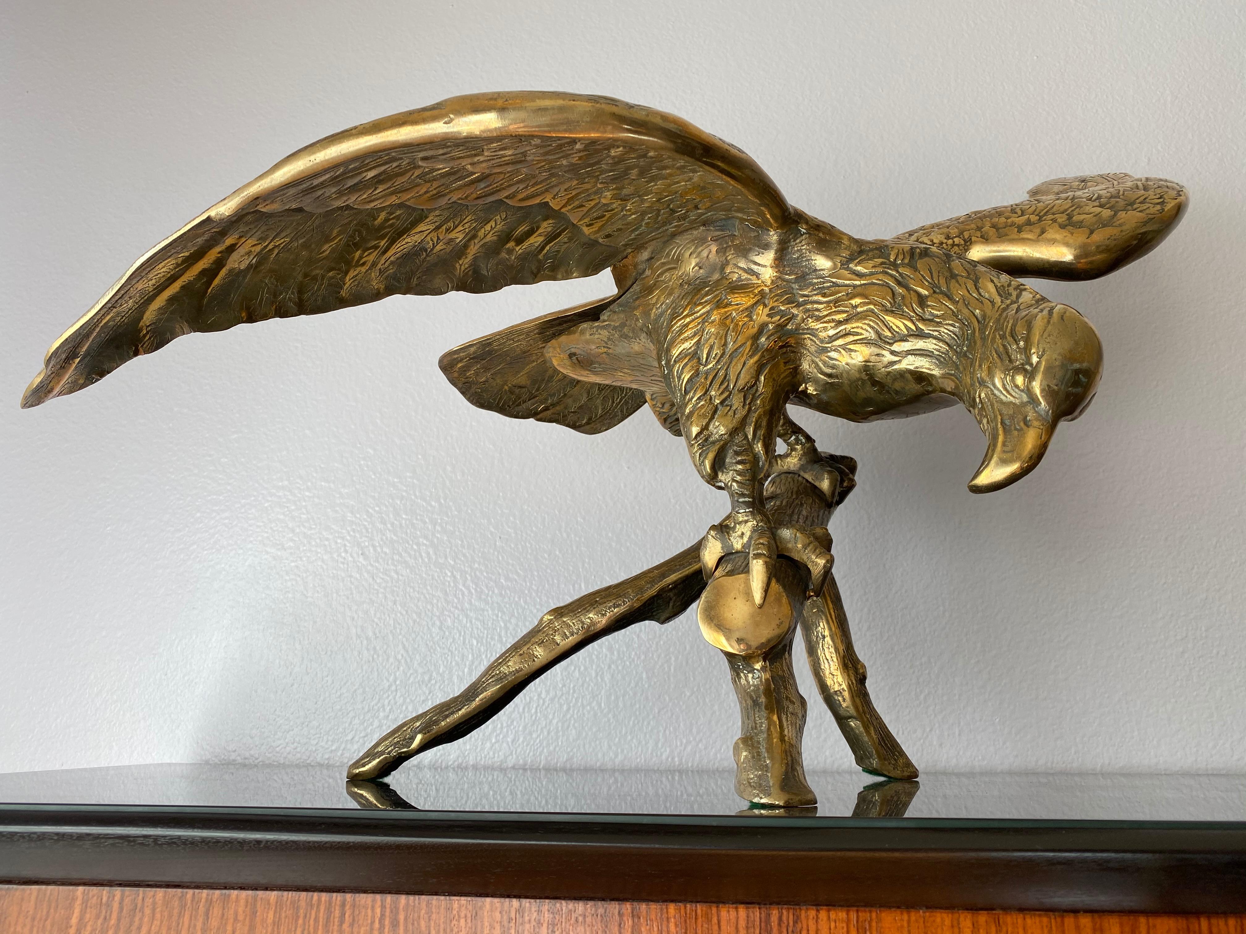 Brass American bald eagle sculpture on tree branch.