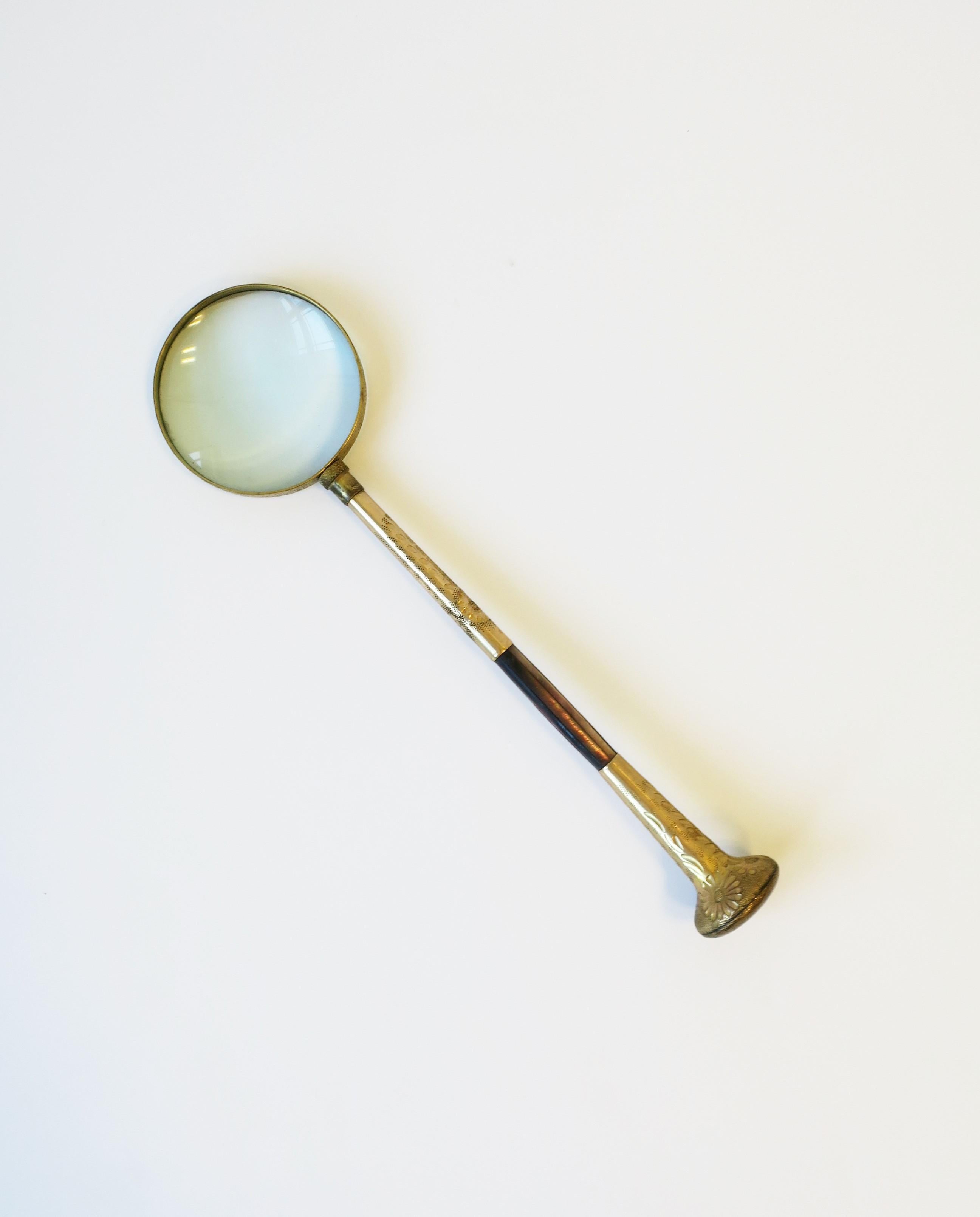 A beautiful and relatively large brass and abalone seashell magnifying glass, circa 20th-century. Handle has abalone seashell inlay and a floral embossed design. A great desk or library accessory. Dimensions: 2.38