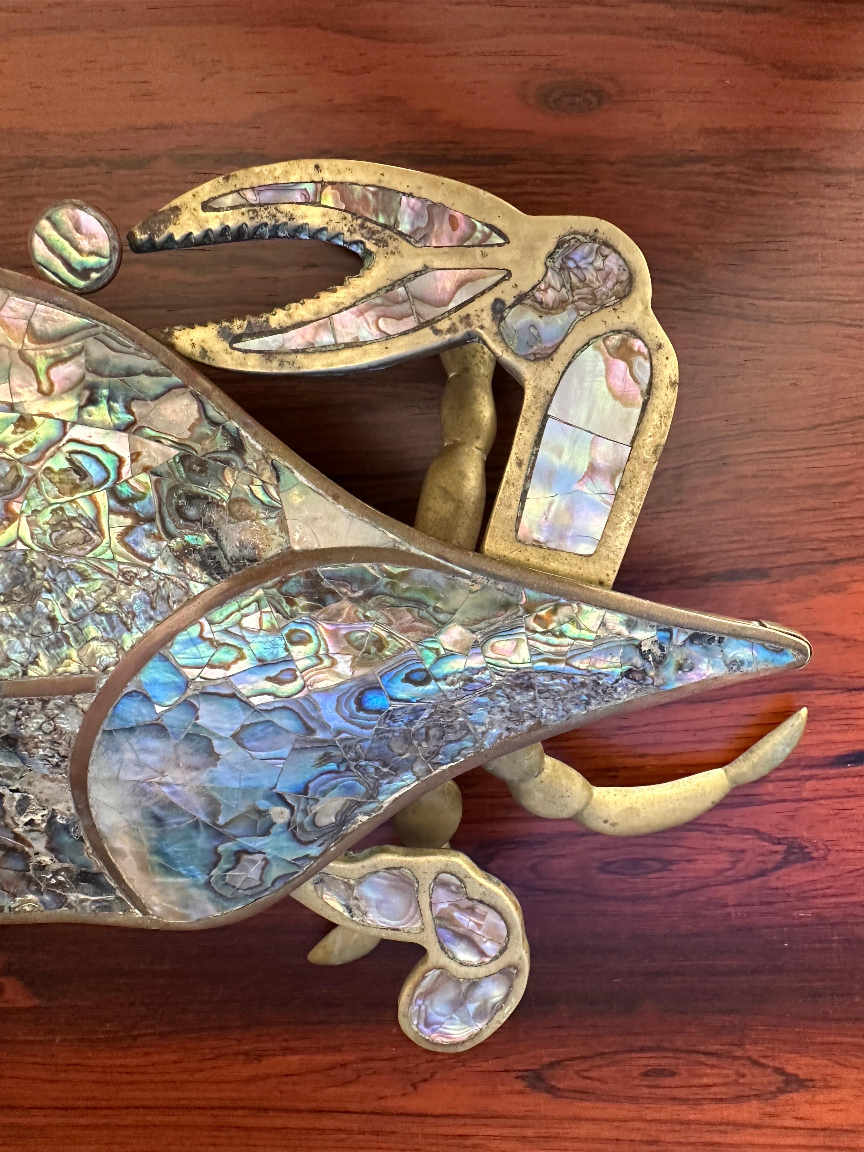 Caja de baratijas escultura de cangrejo de latón con hermosas incrustaciones de concha de abulón. Fabricado en México atribuido a Los Castillos.
Normalmente con el tiempo la tapa se rompe o se pierde, pero está completa y tiene una pátina vintage