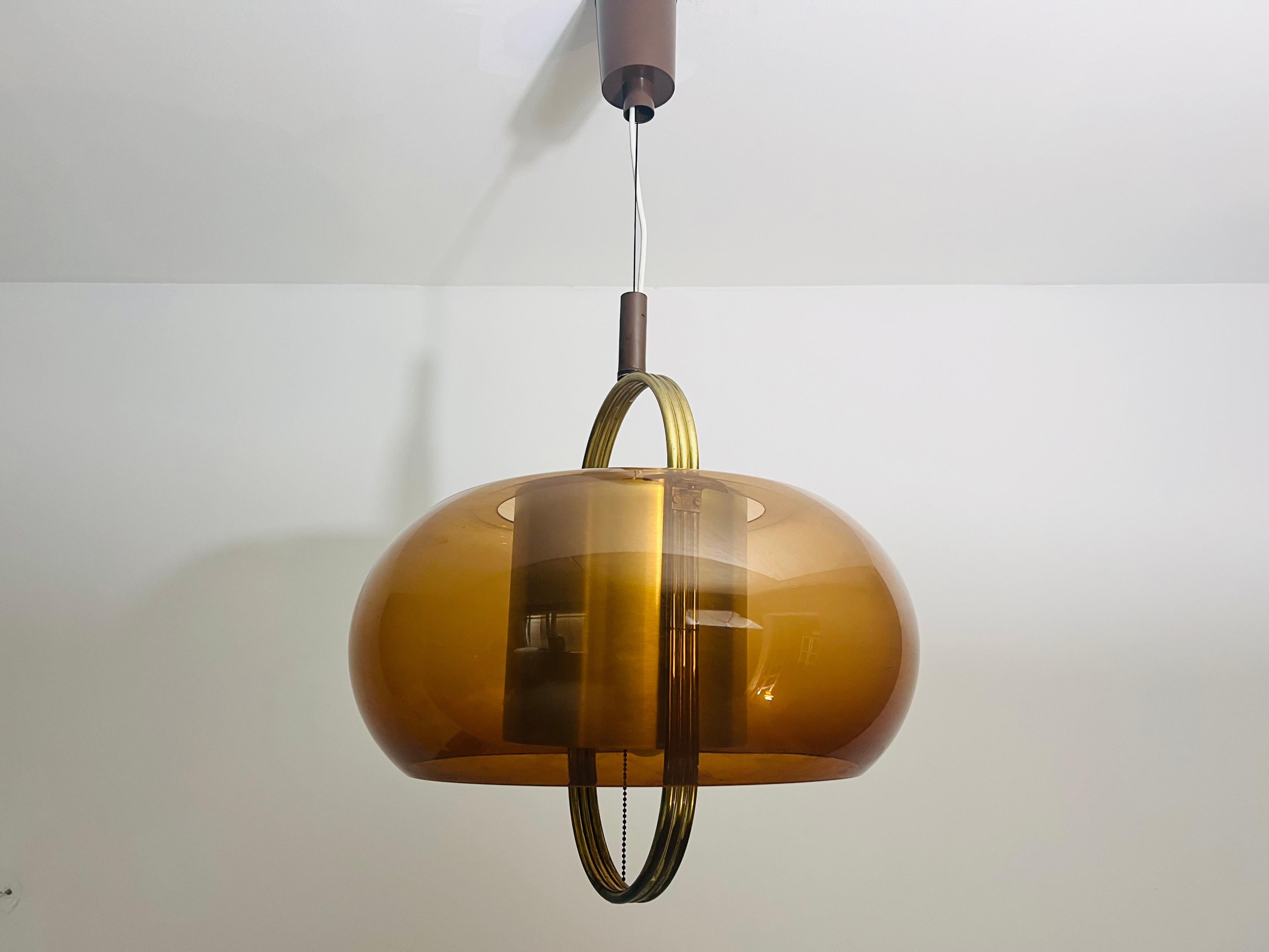 Vintage pendant lamp by Temde from the 1970s, featuring a stylish design crafted from acrylic glass and brass. This elegant fixture showcases the brand’s classic blend of mid-century aesthetics with quality materials, providing a timeless look that