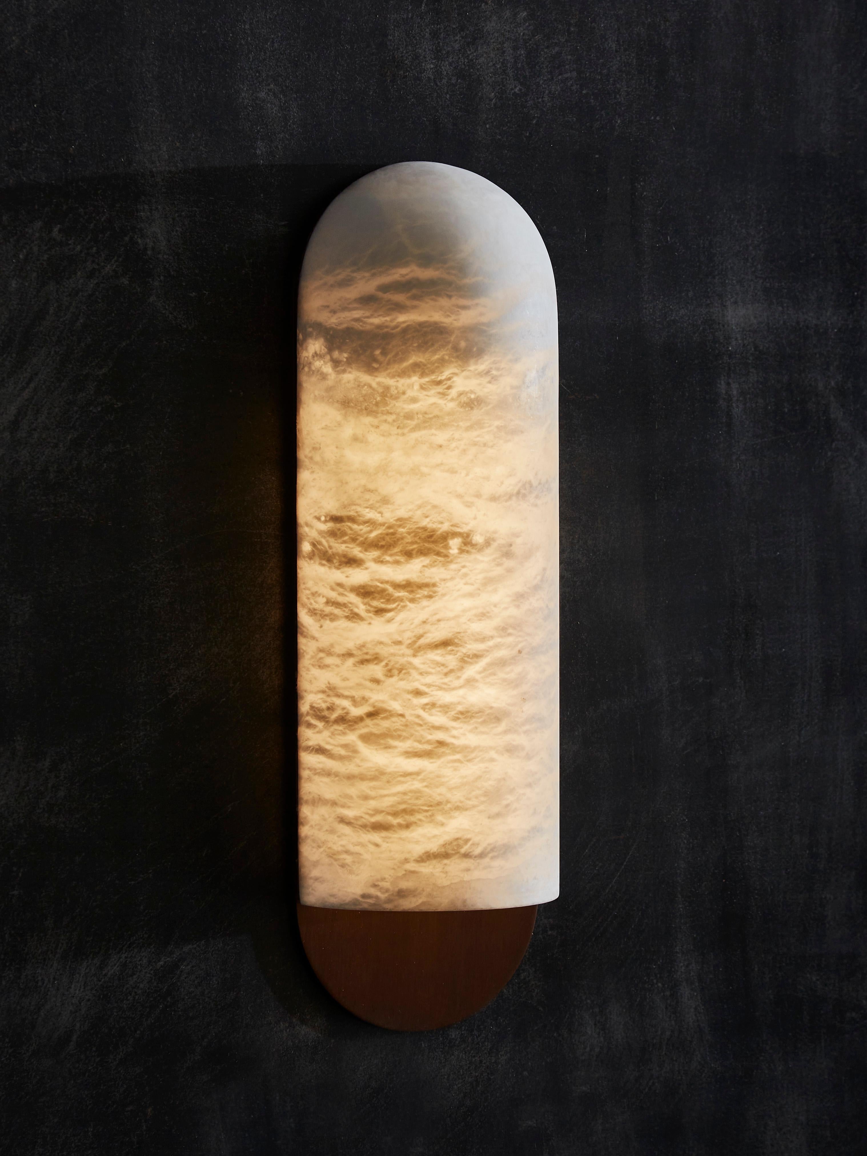 New wall sconces by Glustin Luminaires, they are made of a single rounded and curved carved alabaster piece sat on a light bronze finished brass back plate.


Due to the nature of the alabaster stone, each wall sconce is unique.

Price displayed per