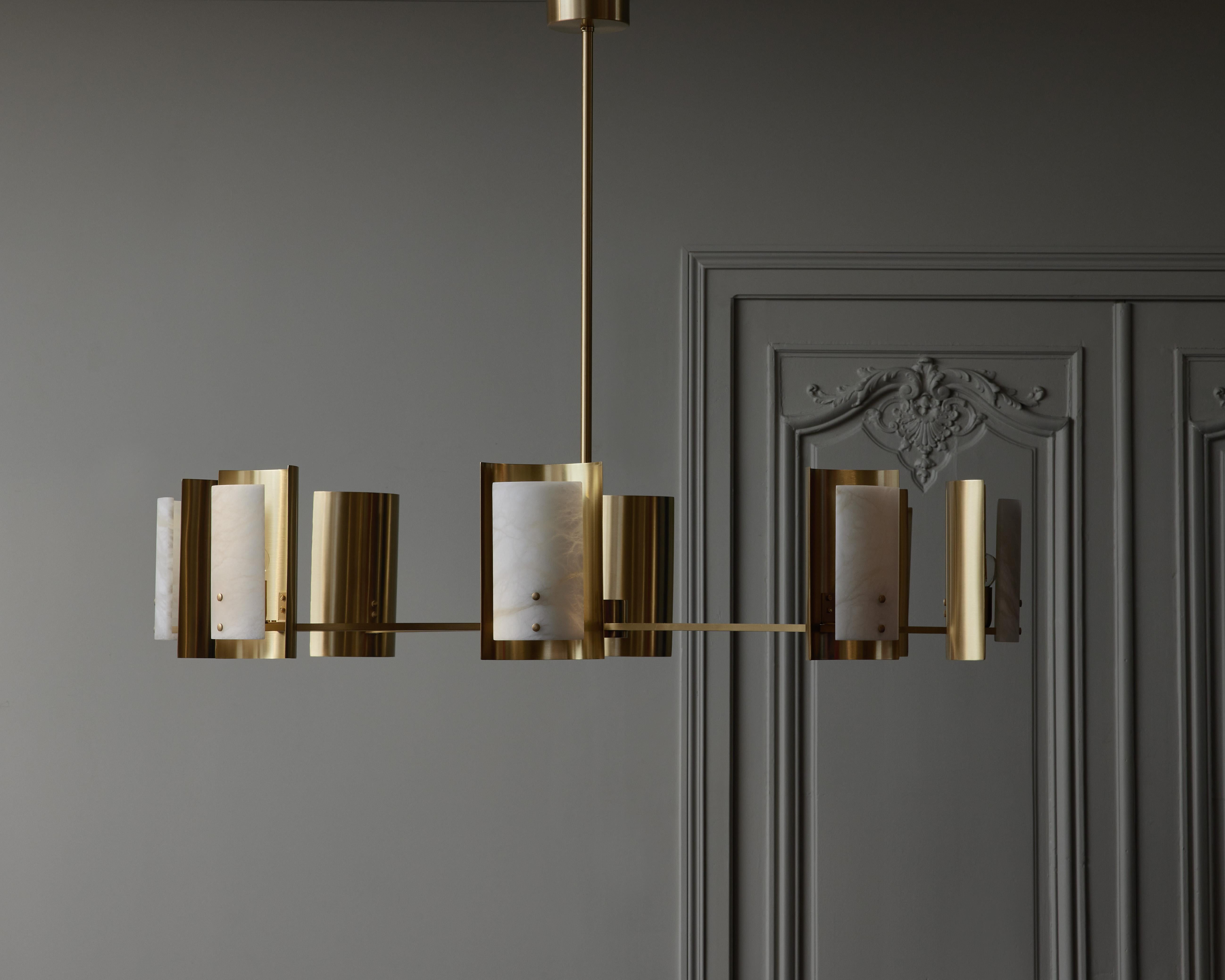 Round chandelier designed by Glustin Luminaires, made of a central vertical stem, eight arms of light each holding a concave satin brass reflector and a convex alabaster diffuser for the source of light.