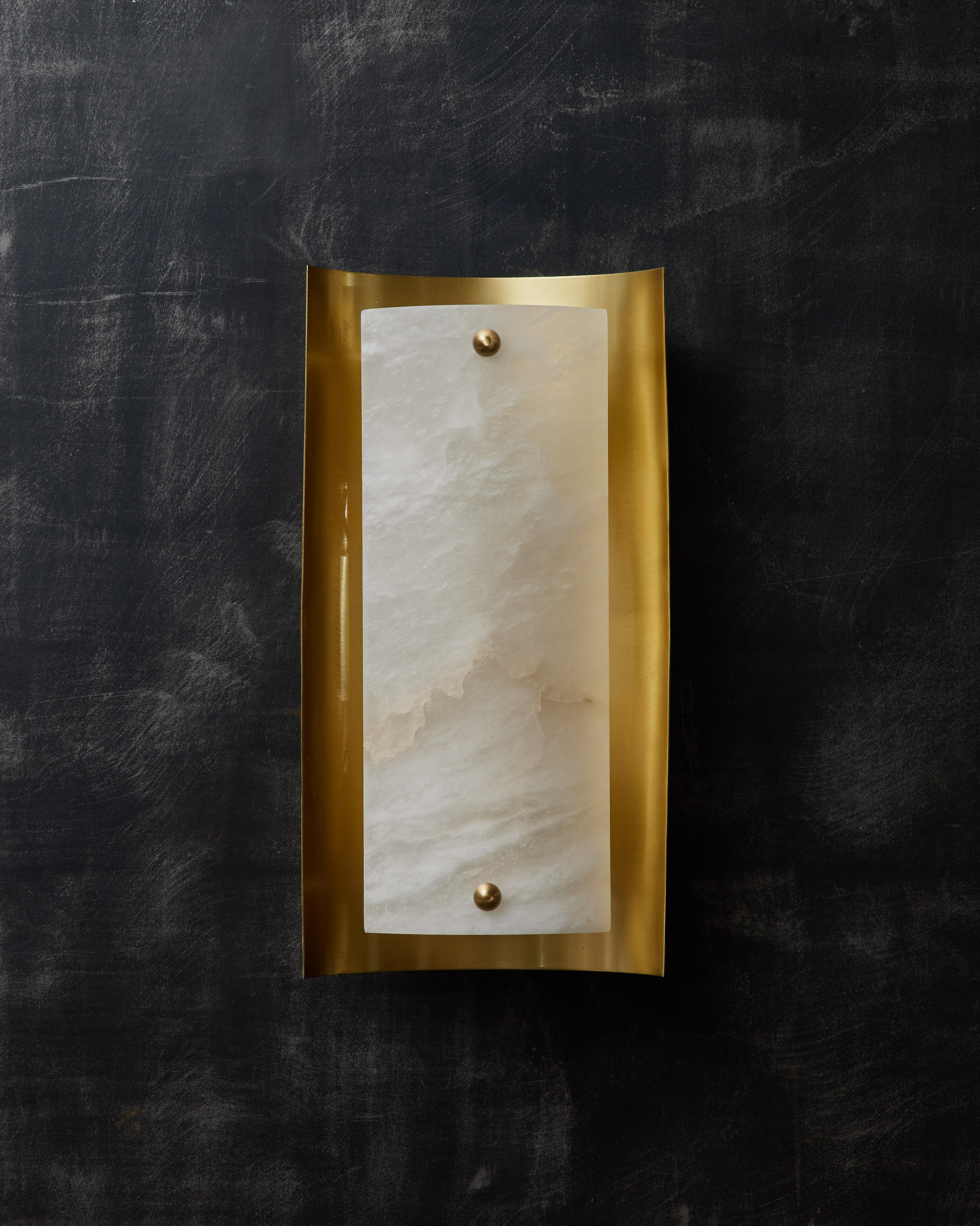 Wall sconce designed by Glustin Luminaires made of a concave satin brass reflector and a convex alabaster diffuser for the source of light.