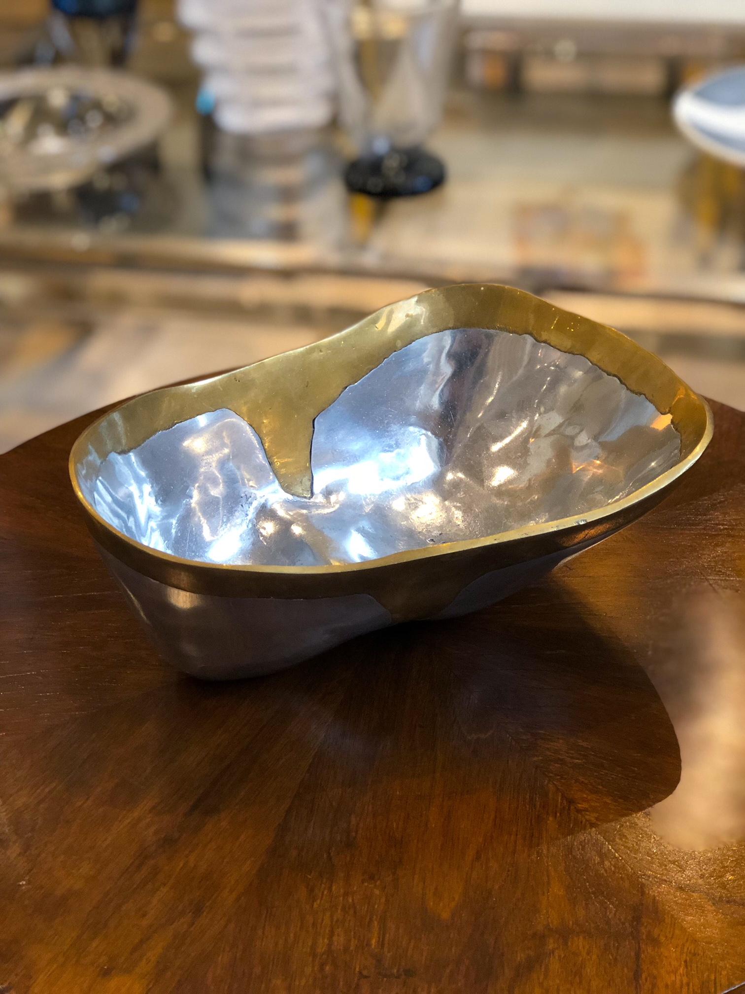 Hand crafted sand cast aluminium and brass bowl by David Marshall. Seville, Spain circa 1970-80.

Size: 10” W x 7” D x 4” H

Aluminium and brass brutalist style tray by David Marshall, circa 1970s. This tray is different than many of Marshall's