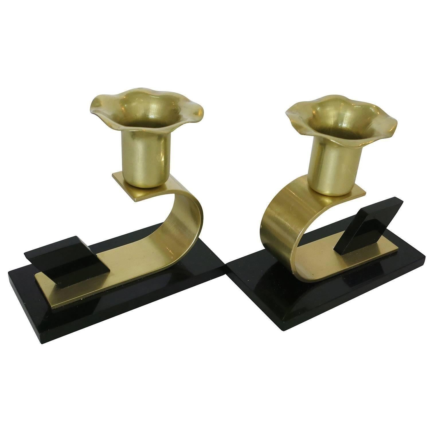 An elegant pair of polished brass and Bakelite Art Deco Modernist floral candle holders designed by the Chase Metalworks Co., of Waterbury, CT.

The 