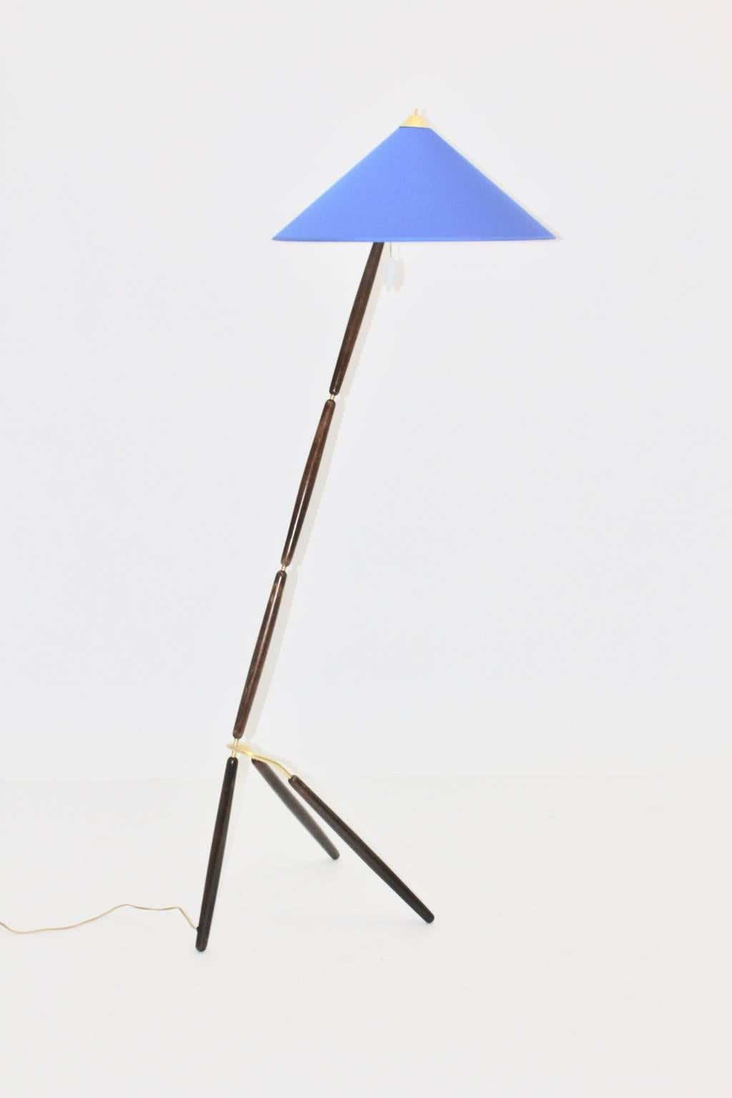 Brass and beech vintage Art Deco floor lamp, which shows design features, which are very similar to Giuseppe Ostuni Italy, circa 1949.
The renewed lamp shade in its original shape has a blue color tone.
We love the floor lamp for its outstanding