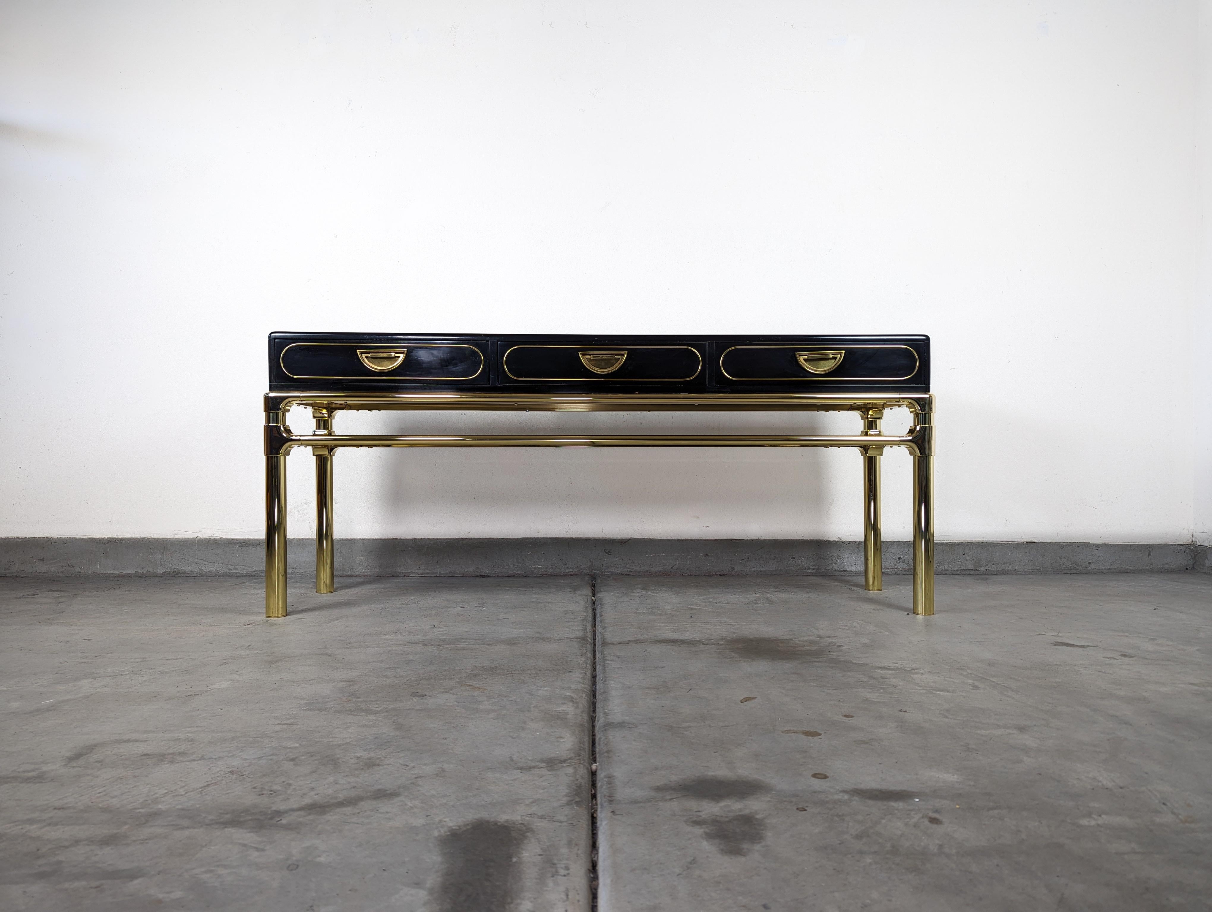 Embrace the timeless elegance of the 1970s with this exquisitely restored vintage Brass and Black Lacquer Console Table by Mastercraft. Known for their high-quality craftsmanship and attention to detail, Mastercraft has been a coveted name in the