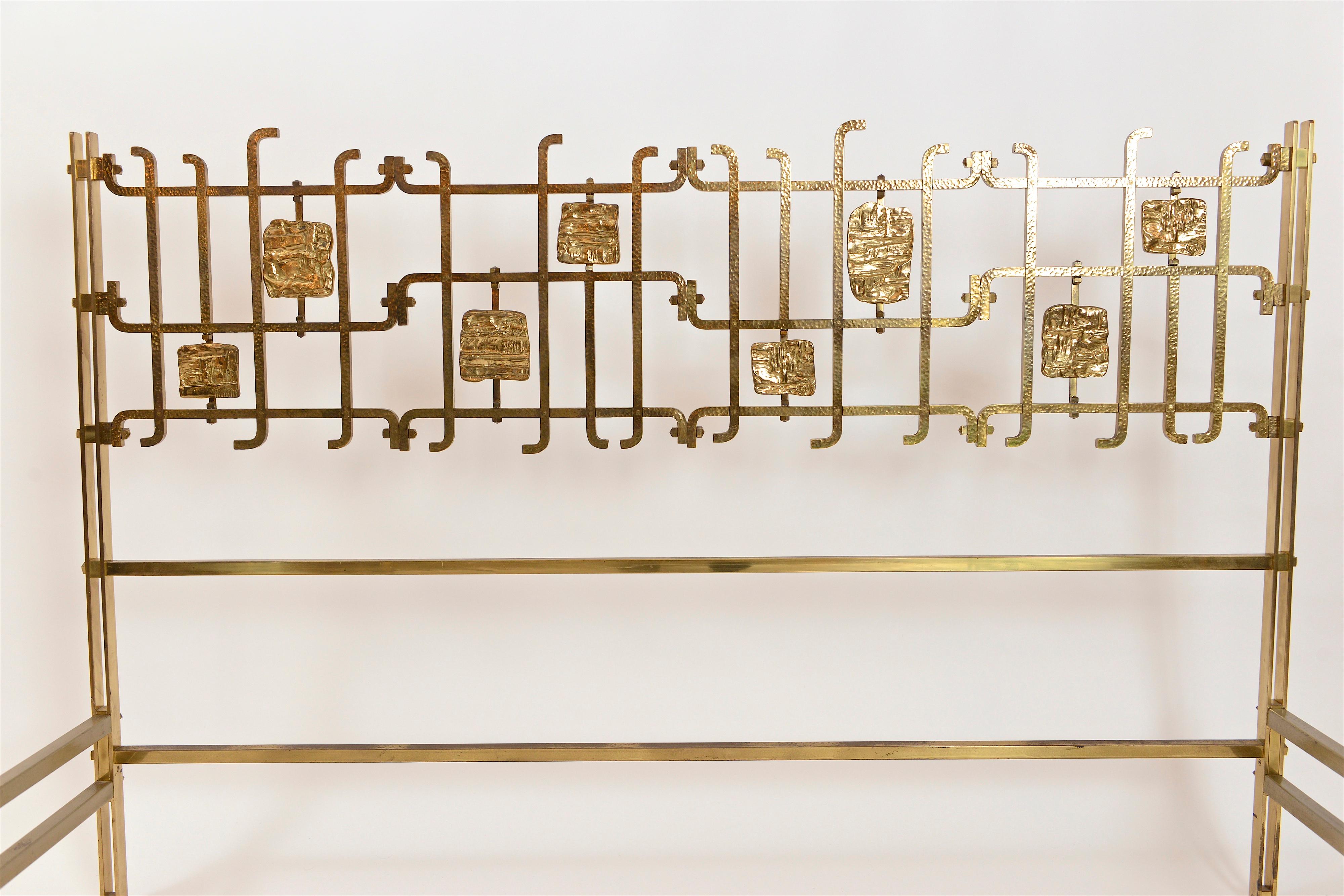 A rare and beautiful bed frame from the Italian designer, Osvaldo Borsani, and sculptor, Arnaldo Pomodoro. Produced circa 1958, the principal structure of the bed, designed by Borsani, is made from solid hammered brass and painted steel supports,