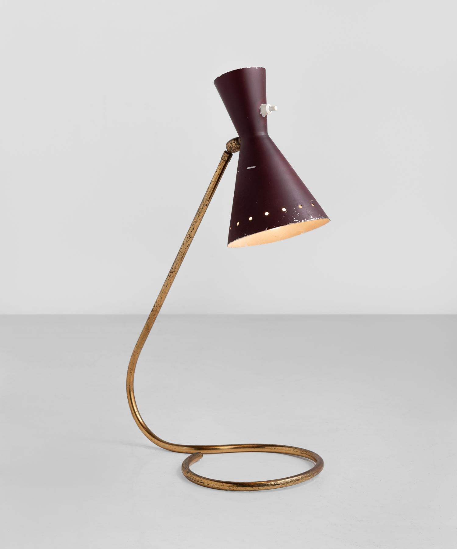 Brass and Burgundy Table Lamp, circa 1950

Painted metal shade sits atop an elegant minimal Stand, which curves into a base.