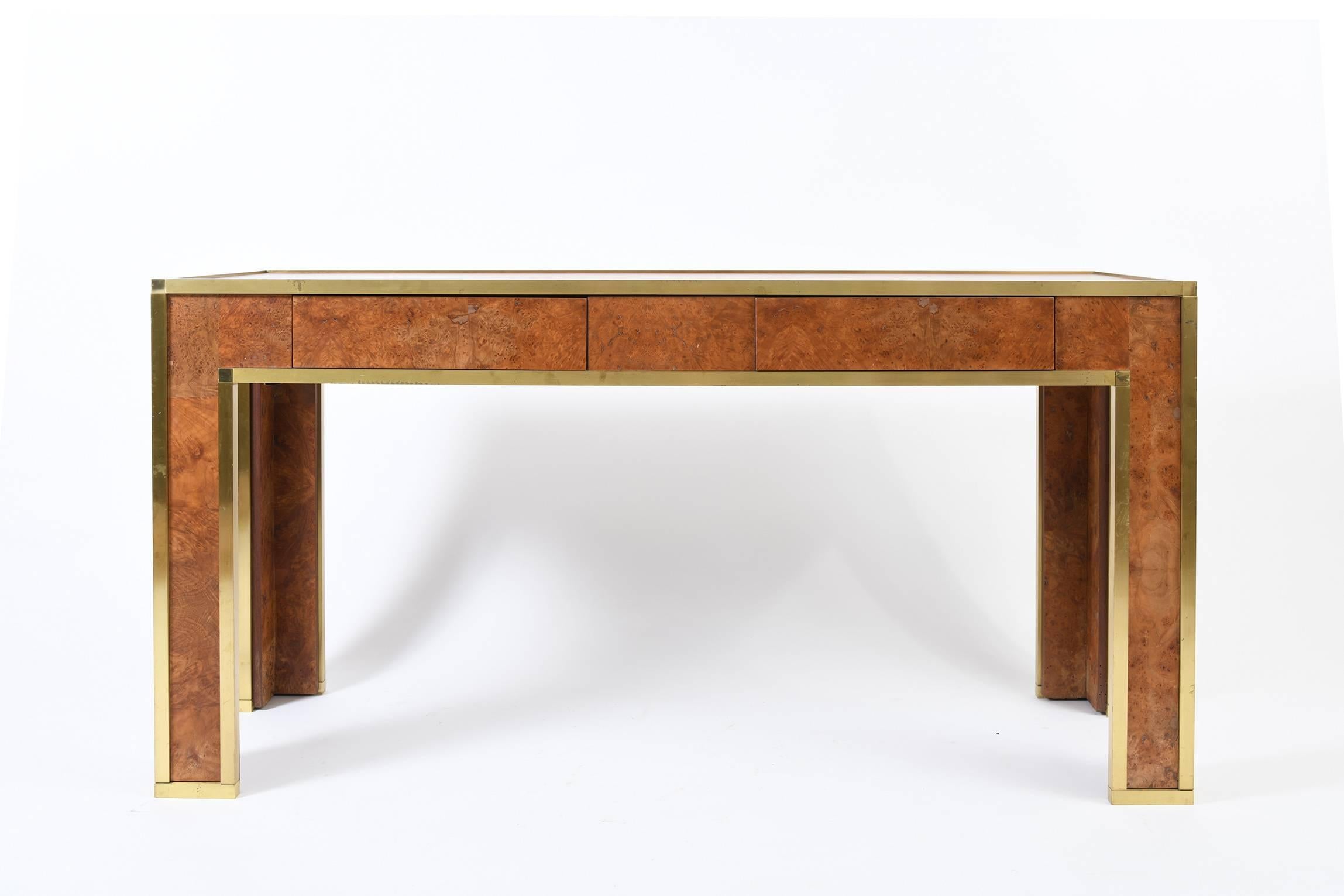 A brass and burr walnut console table - or writing table, opening with two drawers with secret switches to the underside
France, circa 1970.